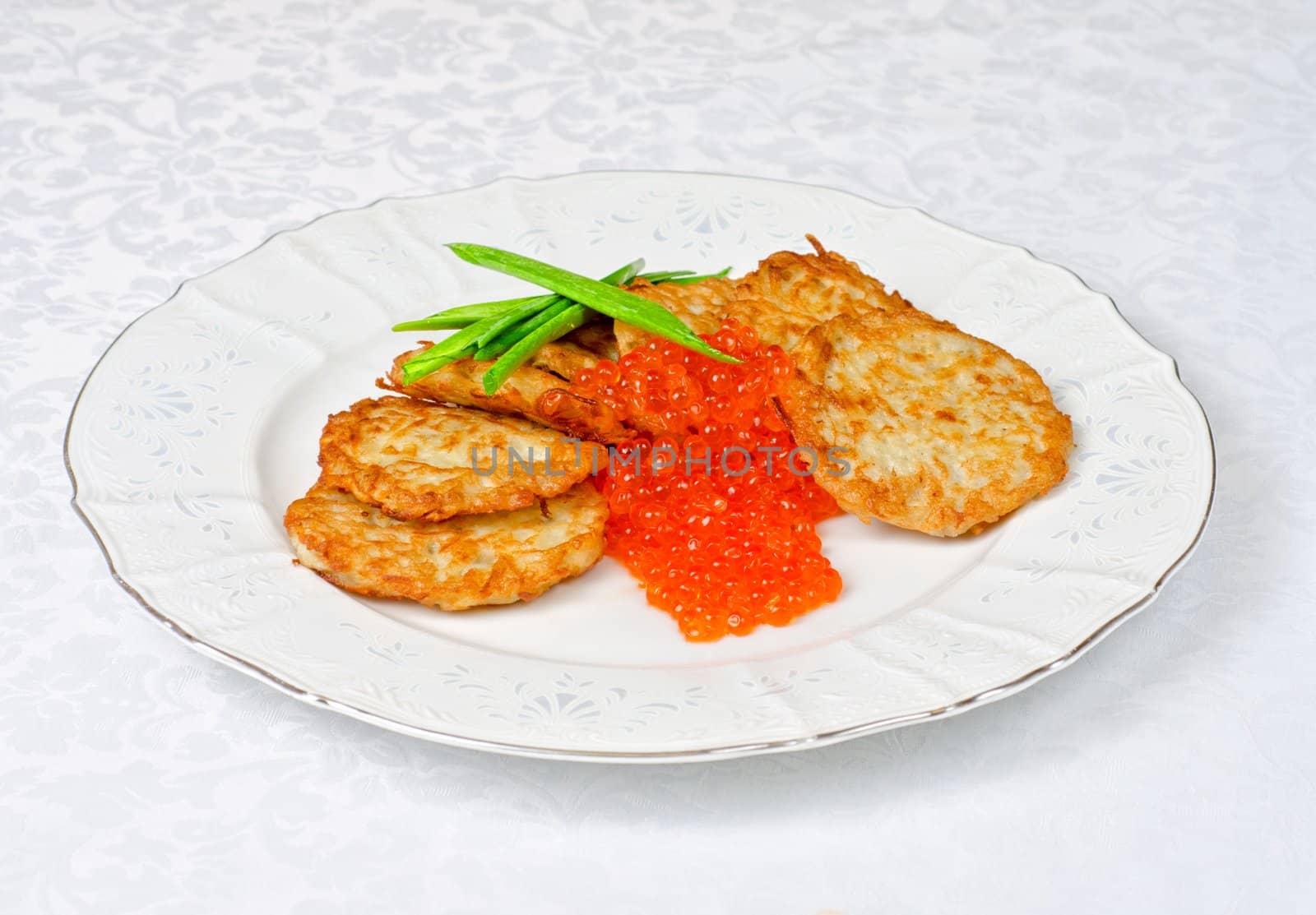 pancakes with red caviar and green onion closeup dish