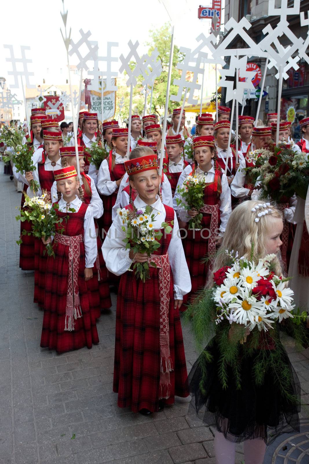 RIGA, LATVIA - JULY 10: A parade by festival participants of Latvian Youth Song and Dance Celebration through the centre of Riga, 10 July, 2010