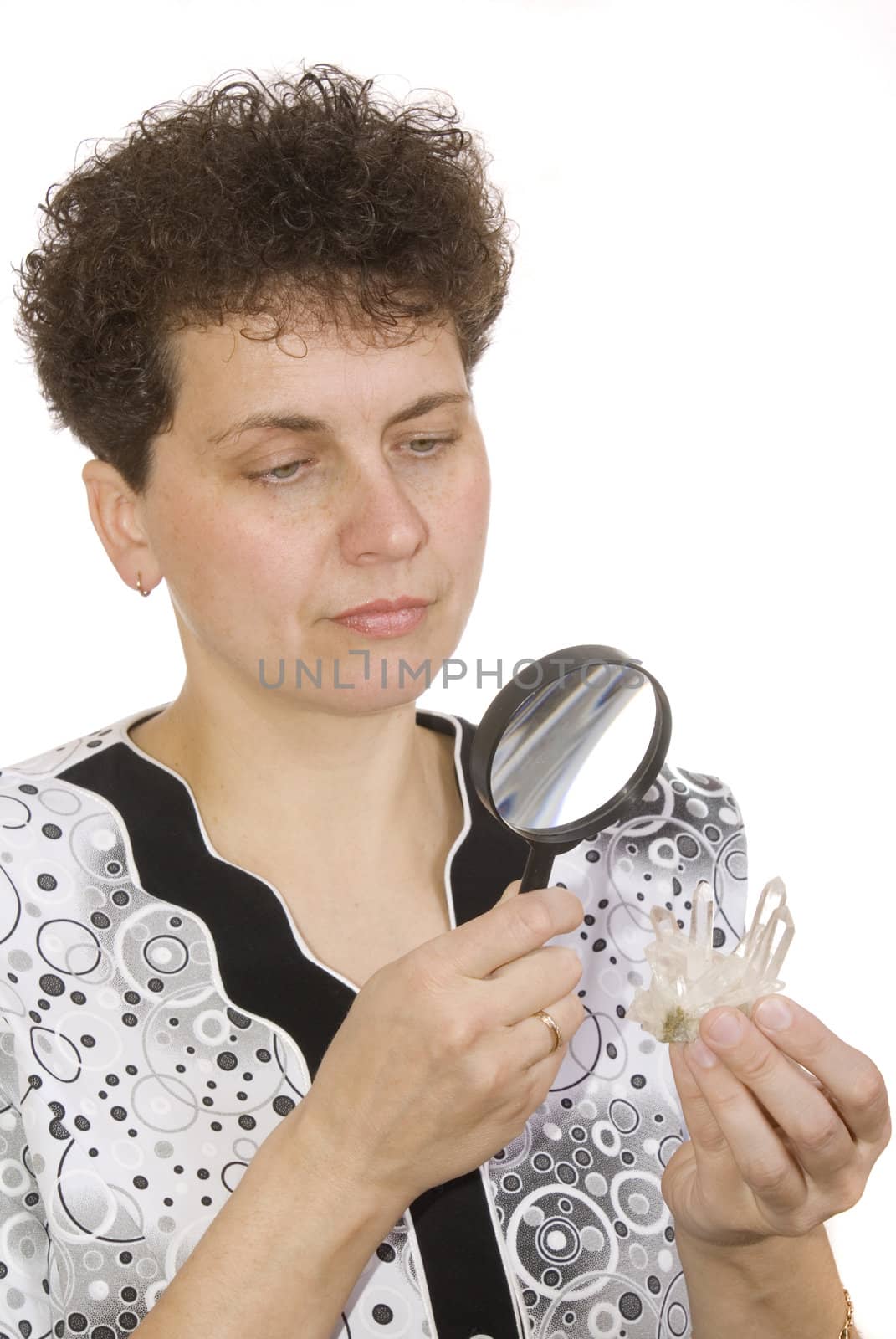 curly woman with magnifying glass and stone on white background