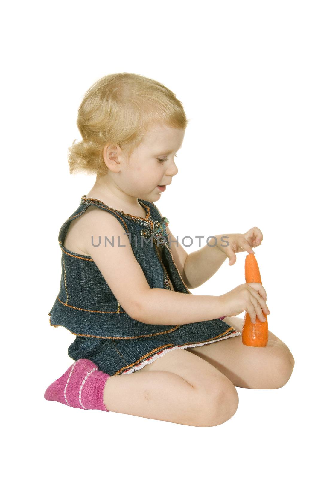 small girl with carrot on white background