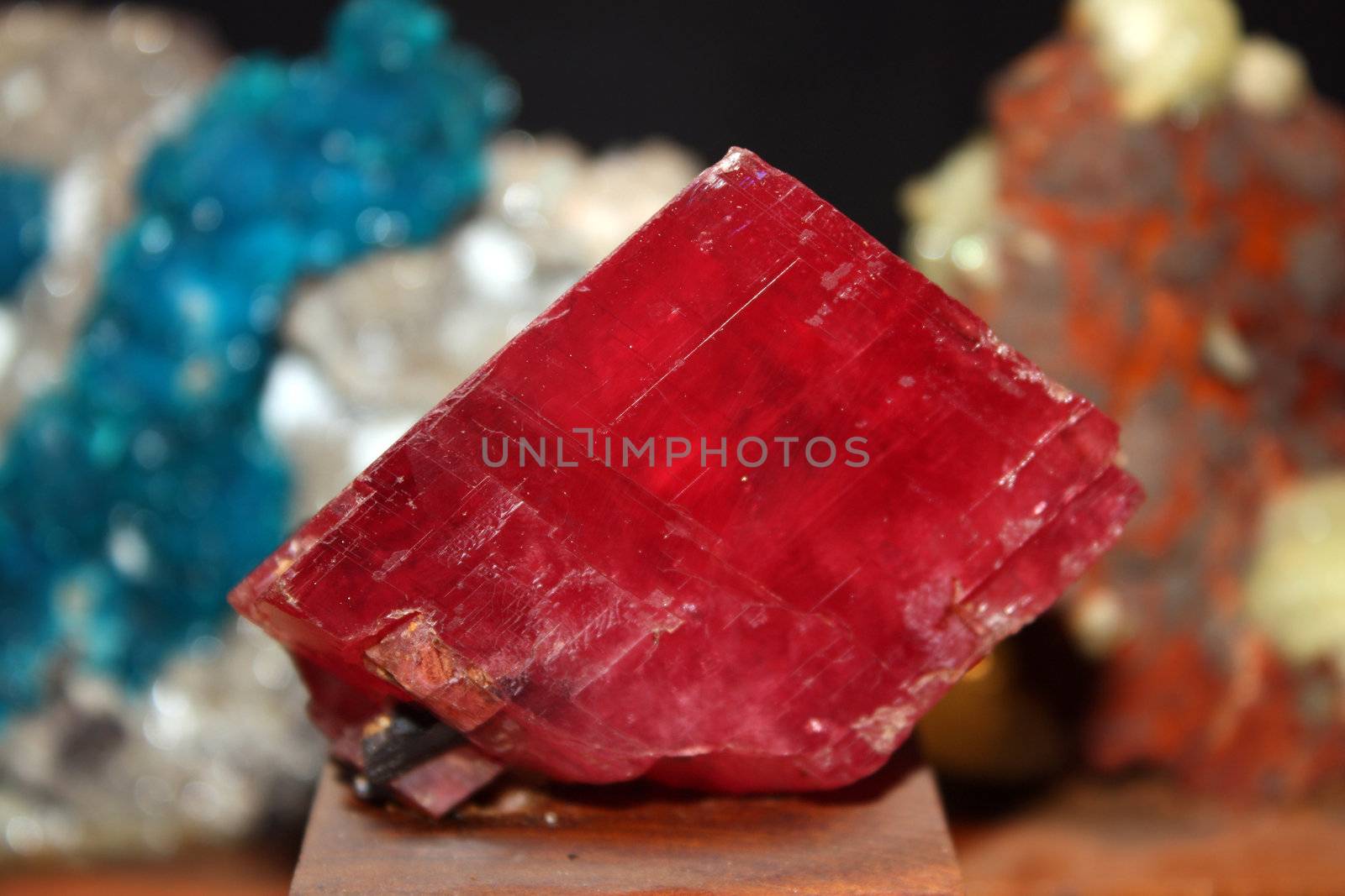 A precious red stone in its raw form, in a mineral museum.