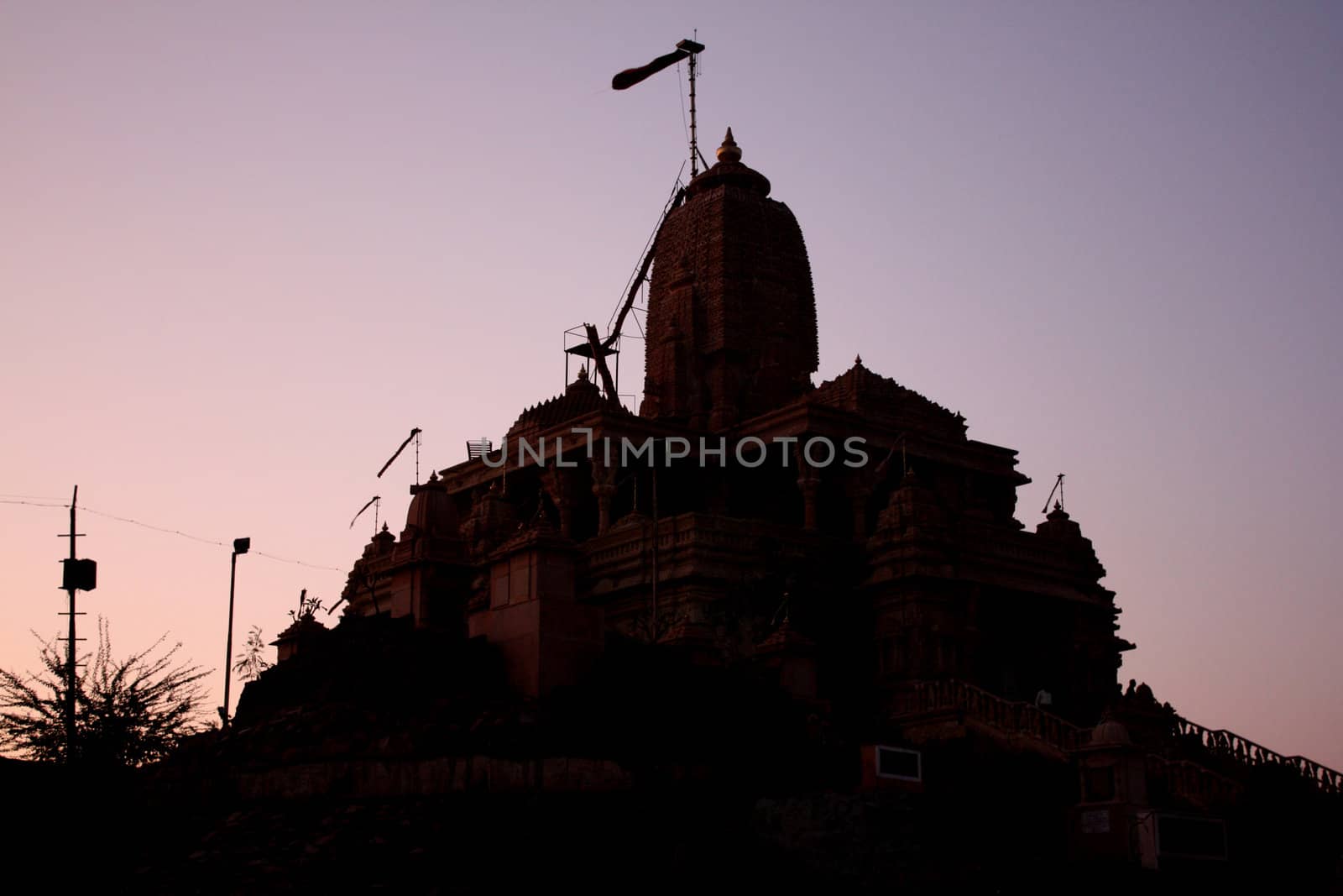 A silhouette of a temple on a twilight sky, in India.