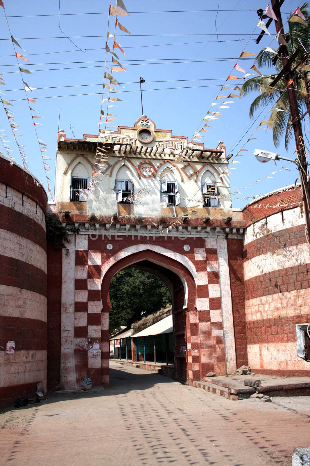 An old fortified entrance gate, to a fort village in India.