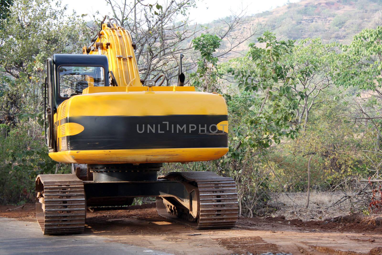 A heavy-duty vehicle used for land moving, used in road construction.