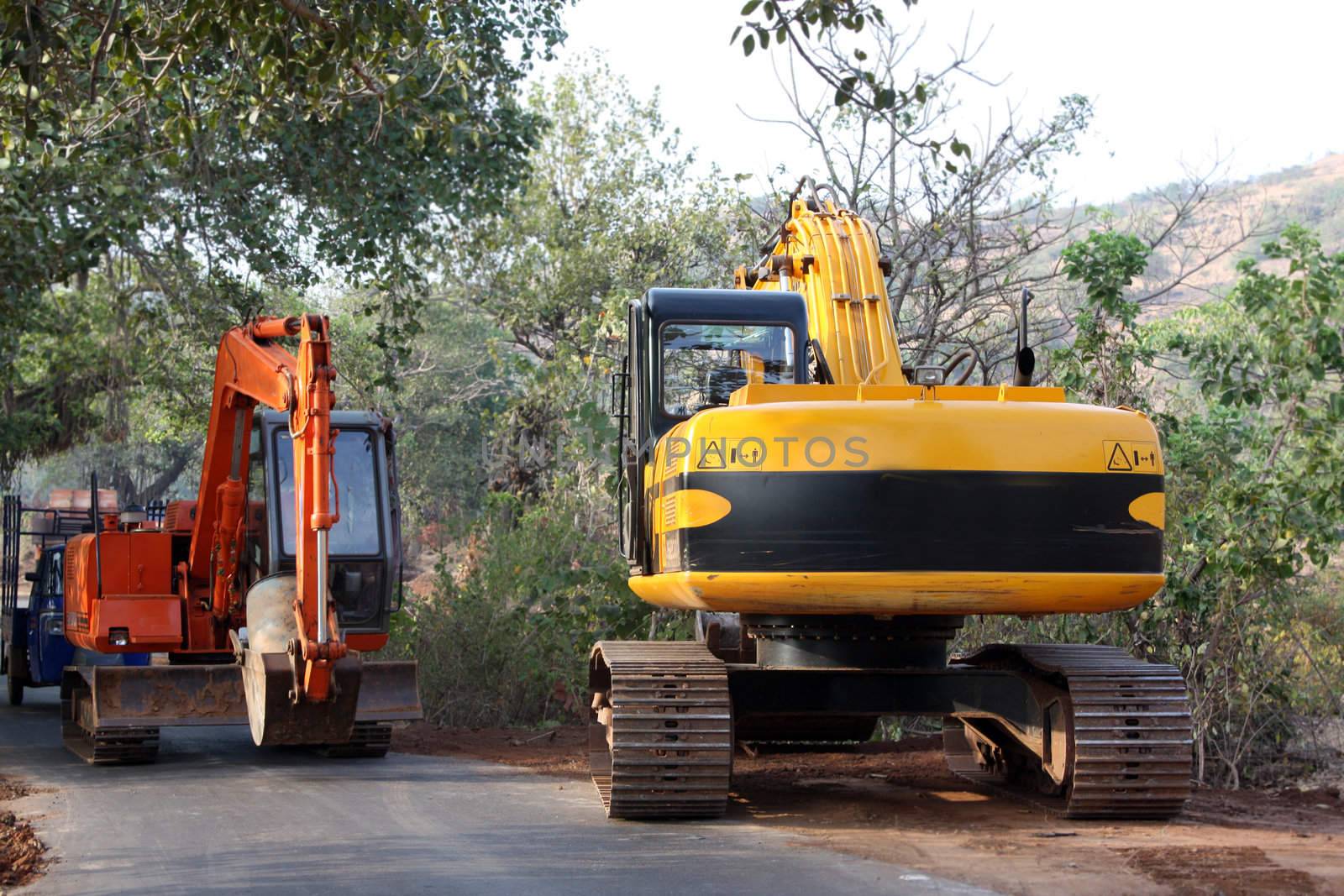 Dozers working at a road construction site, in India.