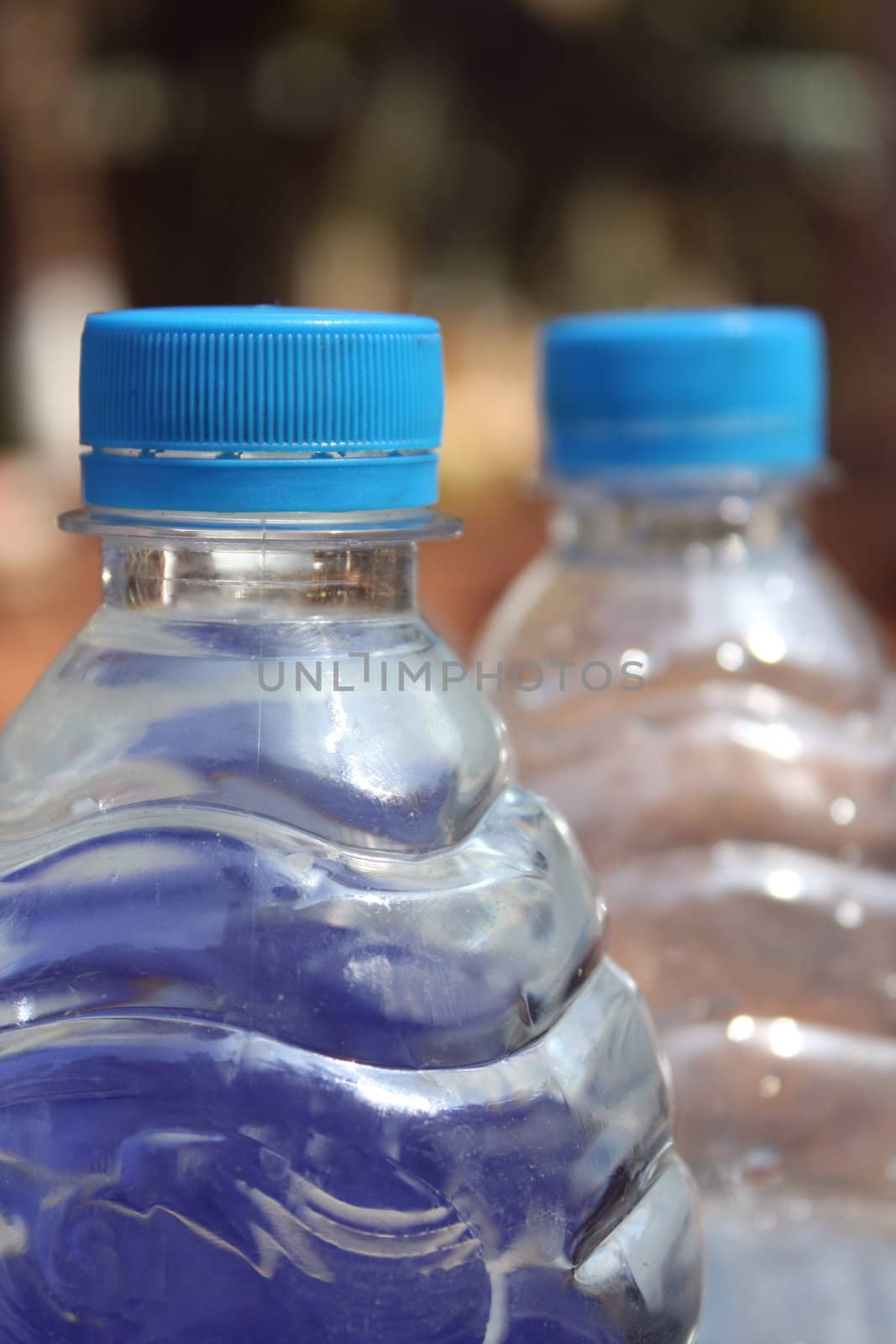 A view of the blue caps of mineral water bottles (Focus on cap).