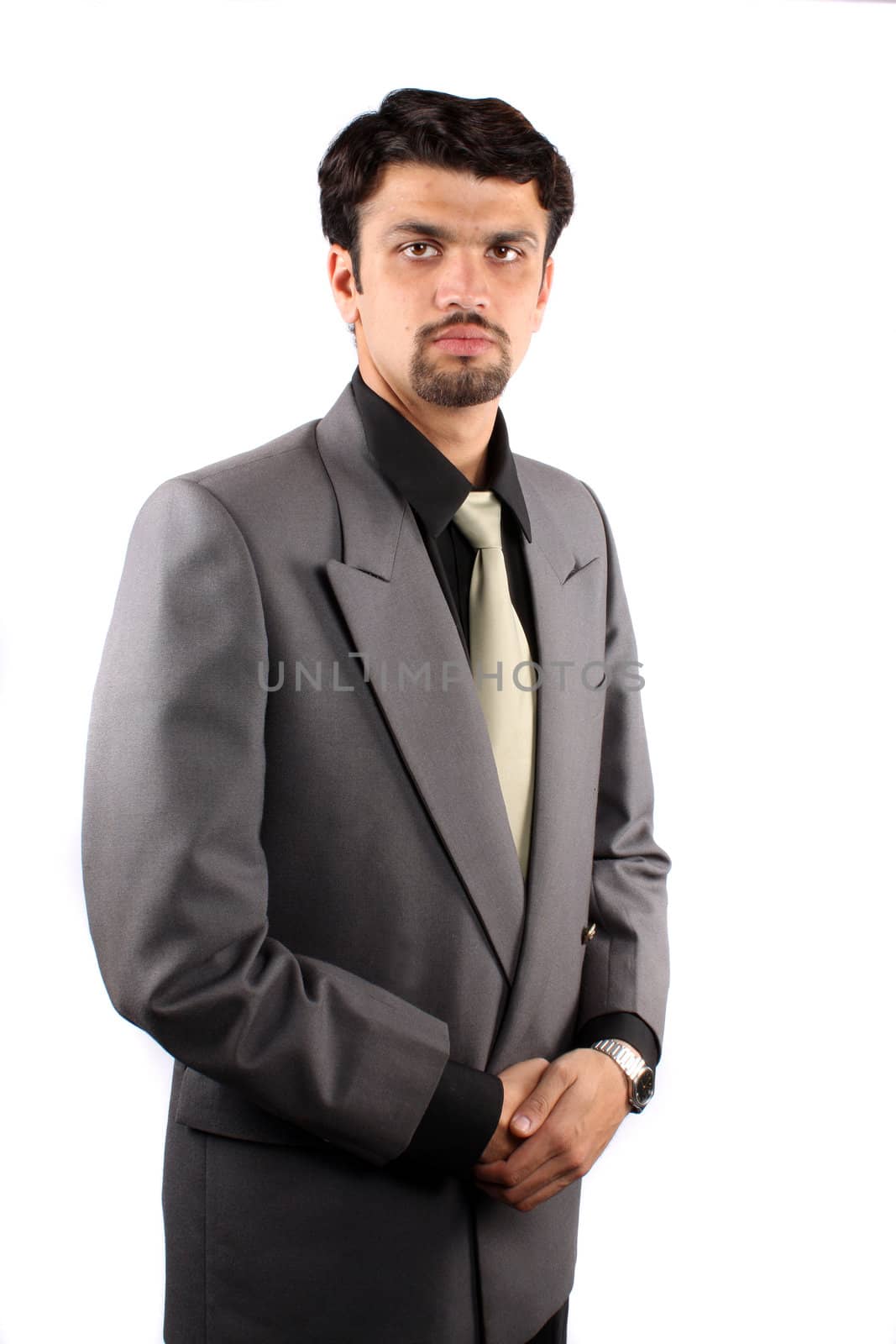 A portrait of a handsome young Indian businessman, isolated on white studio background.