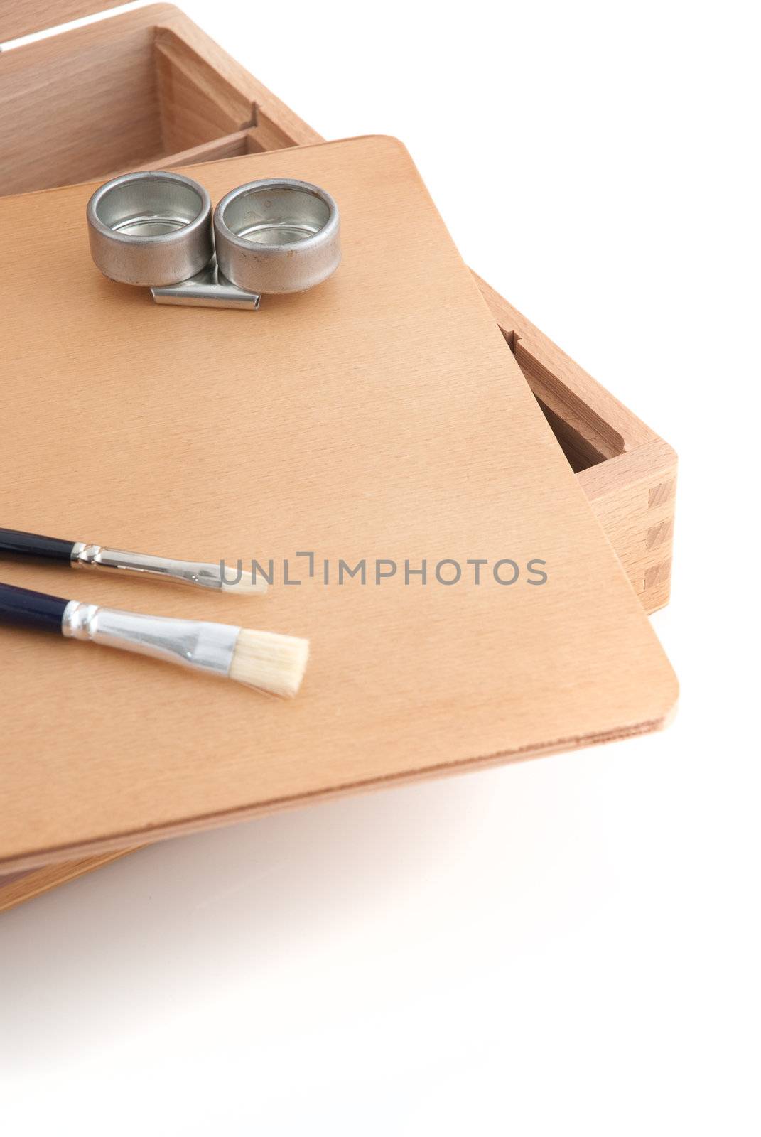 Wooden painter case with brushes on white background.