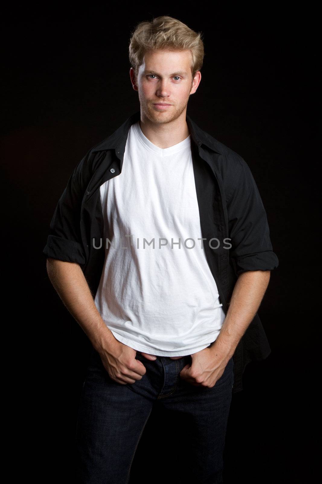 Cool young blond man standing