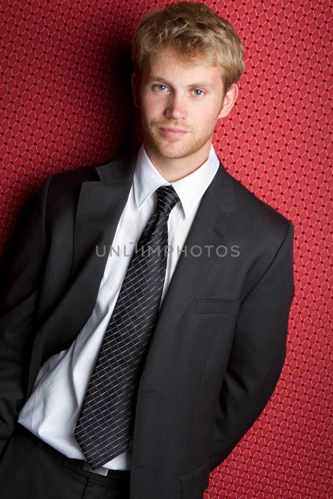 Young handsome businessman wearing suit