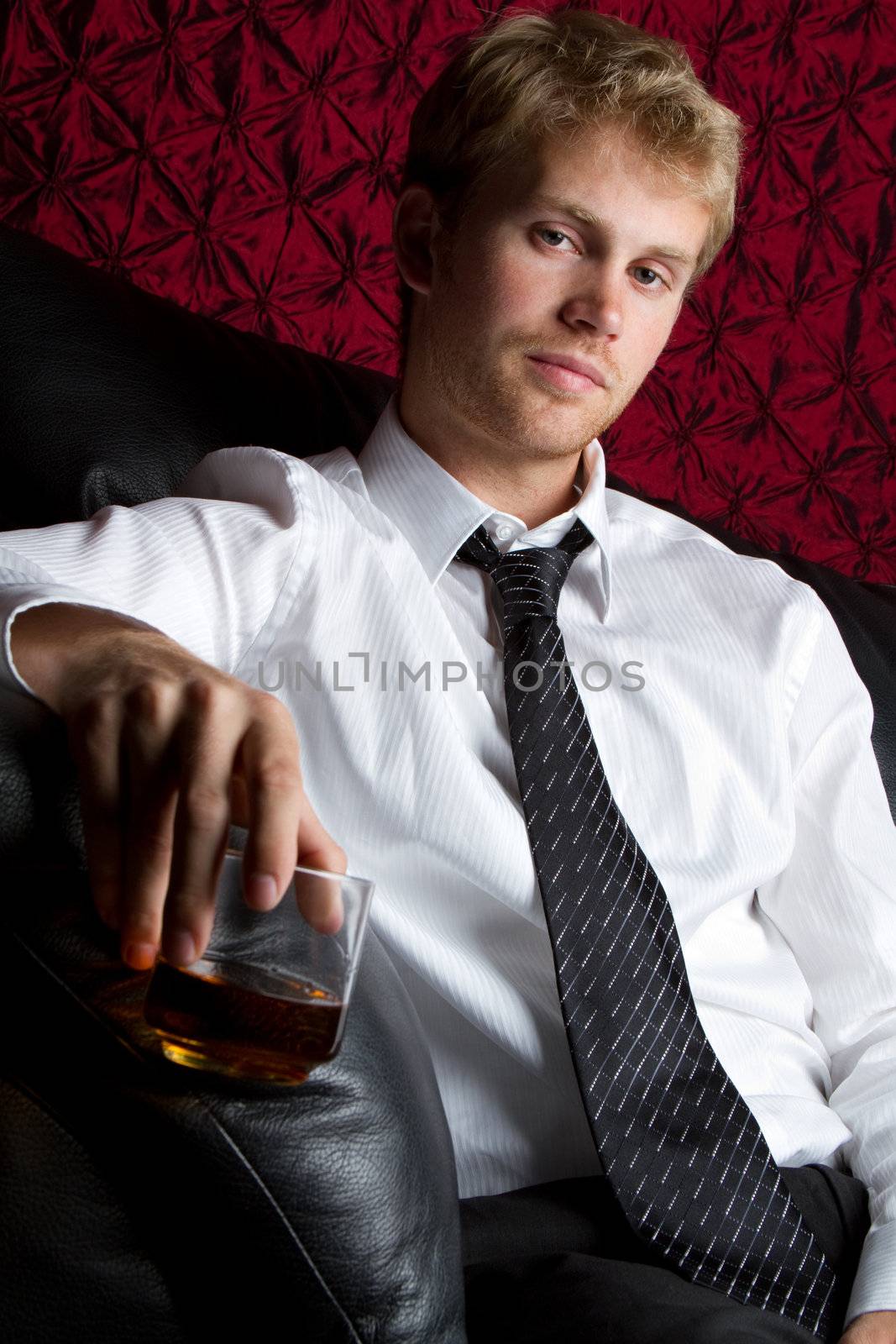 Young man drinking scotch alcohol