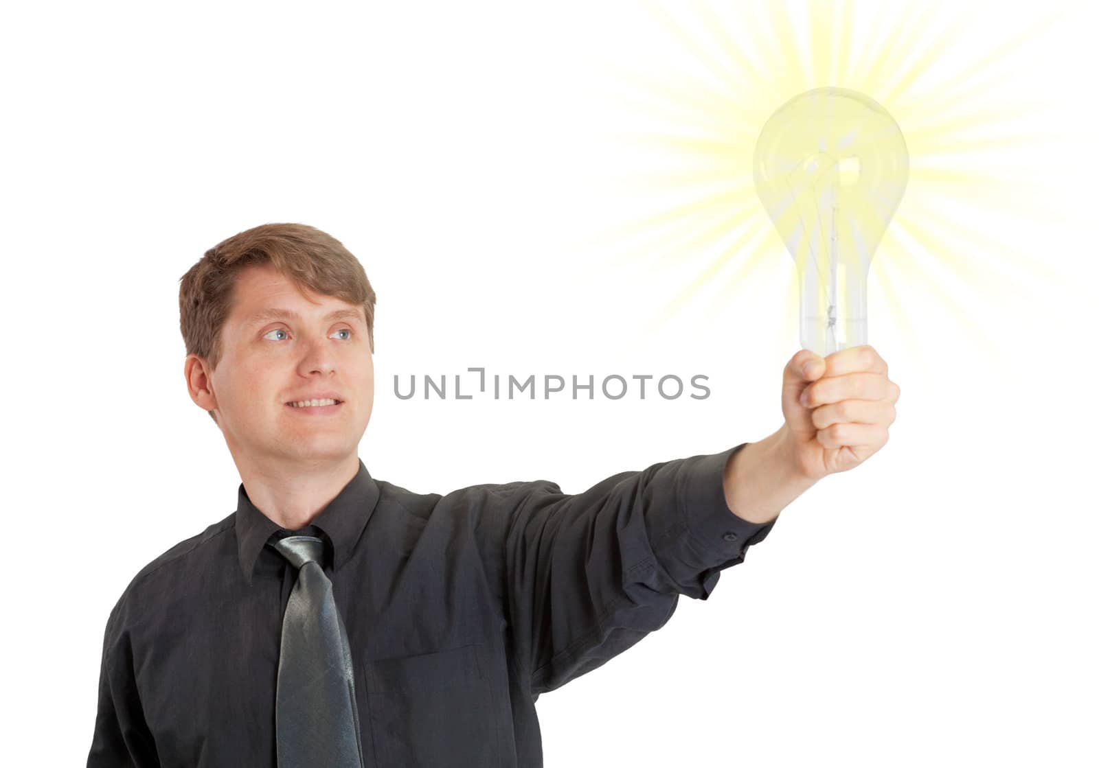 Young man lit by bright idea in form of electric light by pzaxe