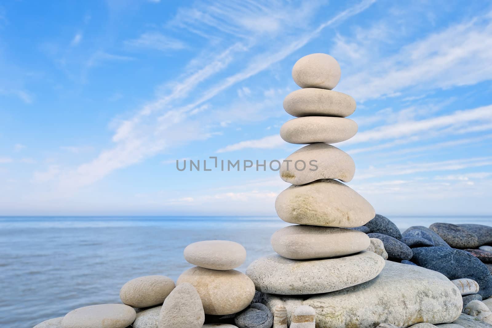The stack of the round pebbles on the background of the cloudy sky