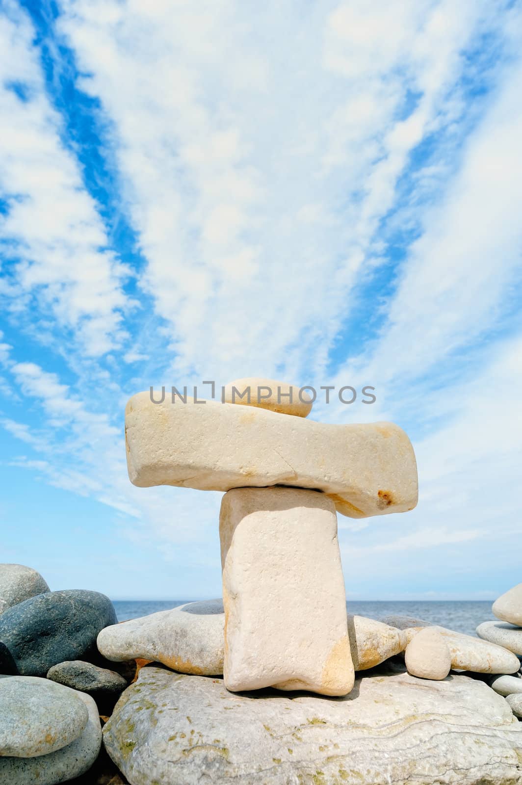 Stack of pebbles against the blue sky