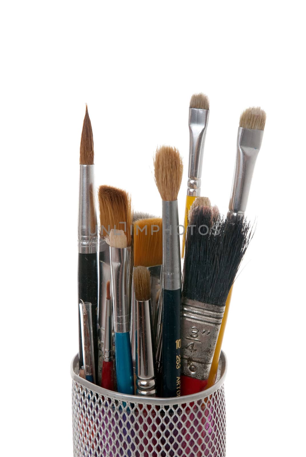 Paintbrushes in a metal mesh holder on white background.