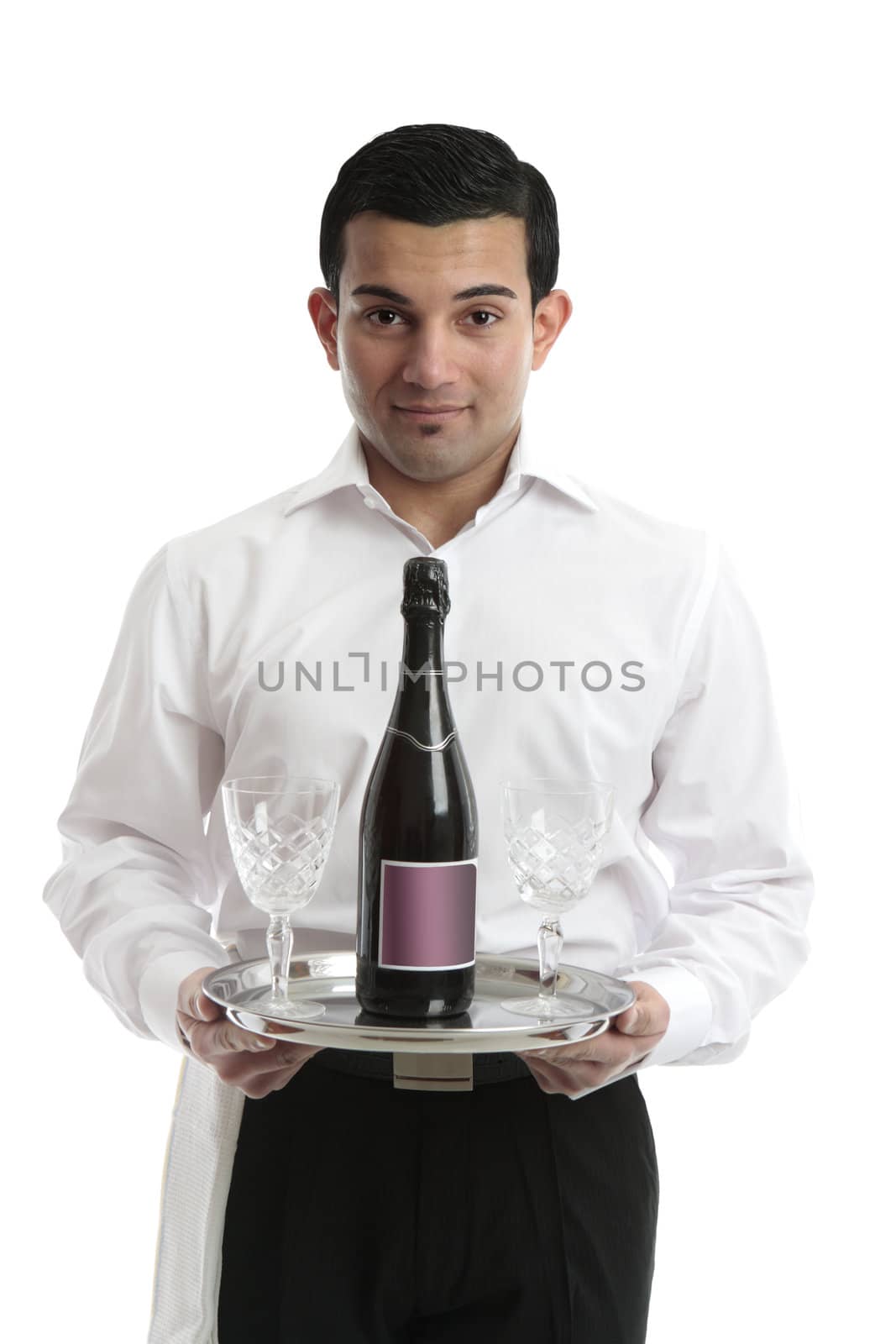 A waiter, servant or bartender bringing a bottle of wine and wine glasses on a silver tray.