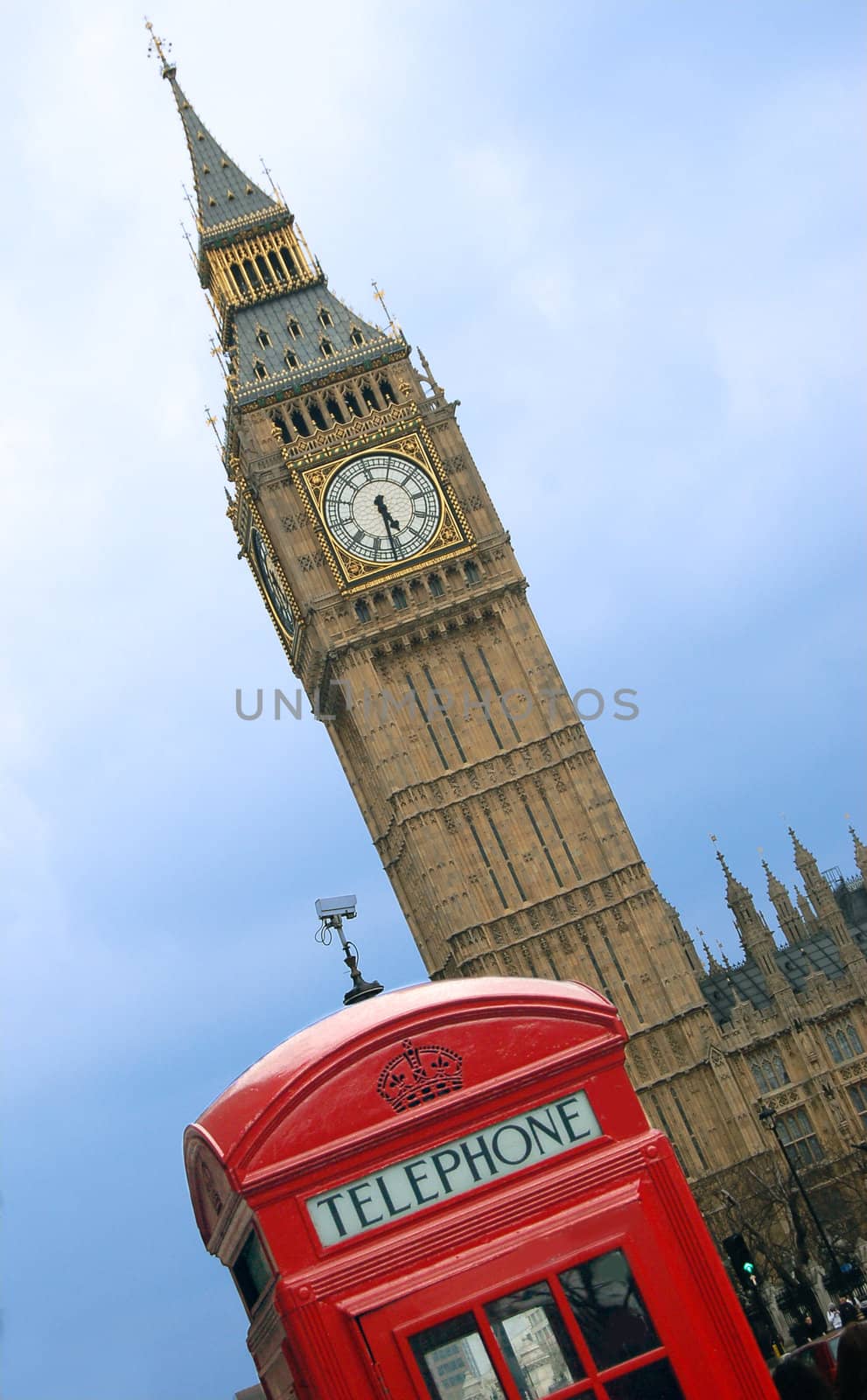 Big Ben and telephone cabin in London over blue sky 