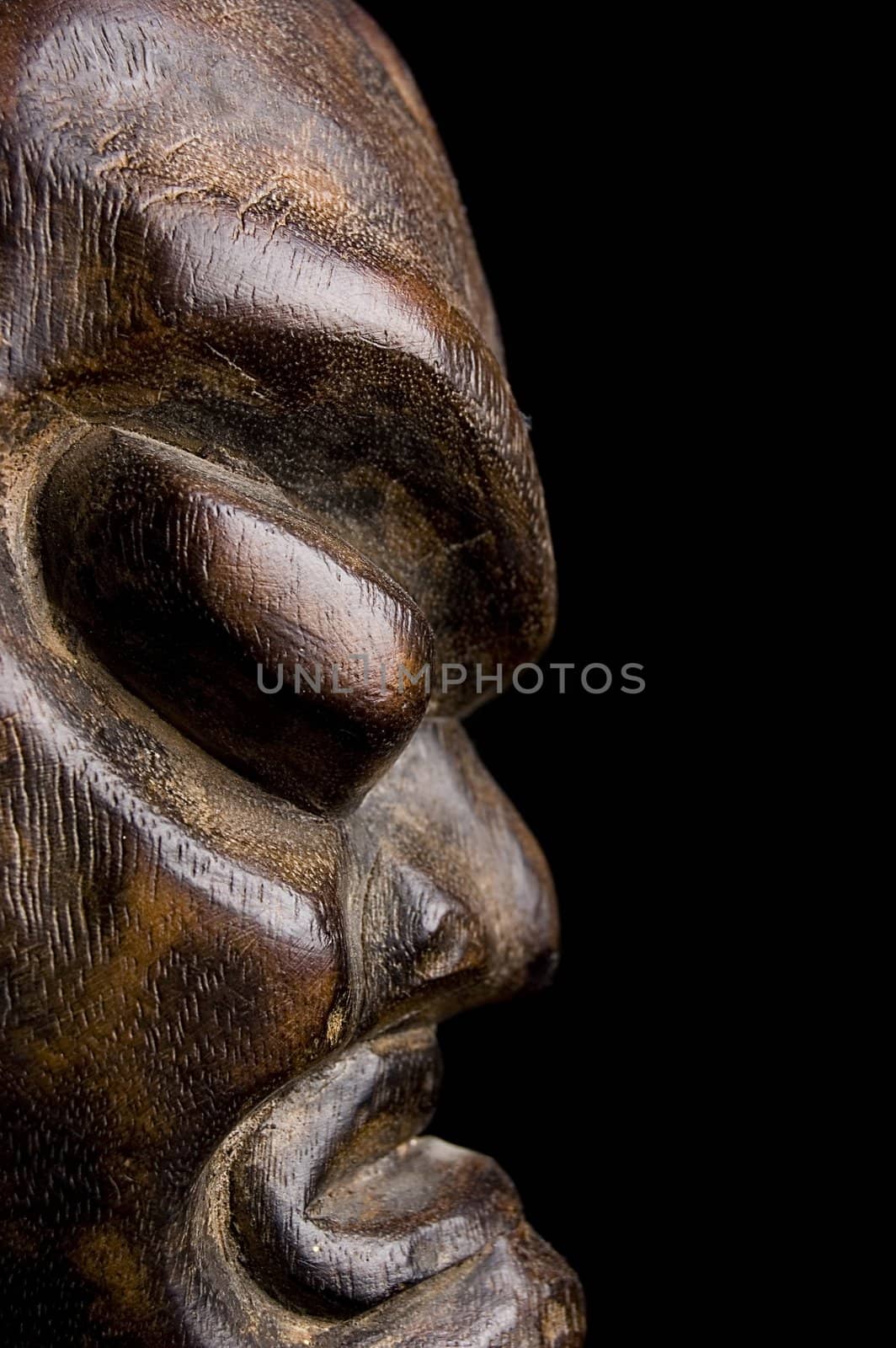 African mask over black background by johnnychaos