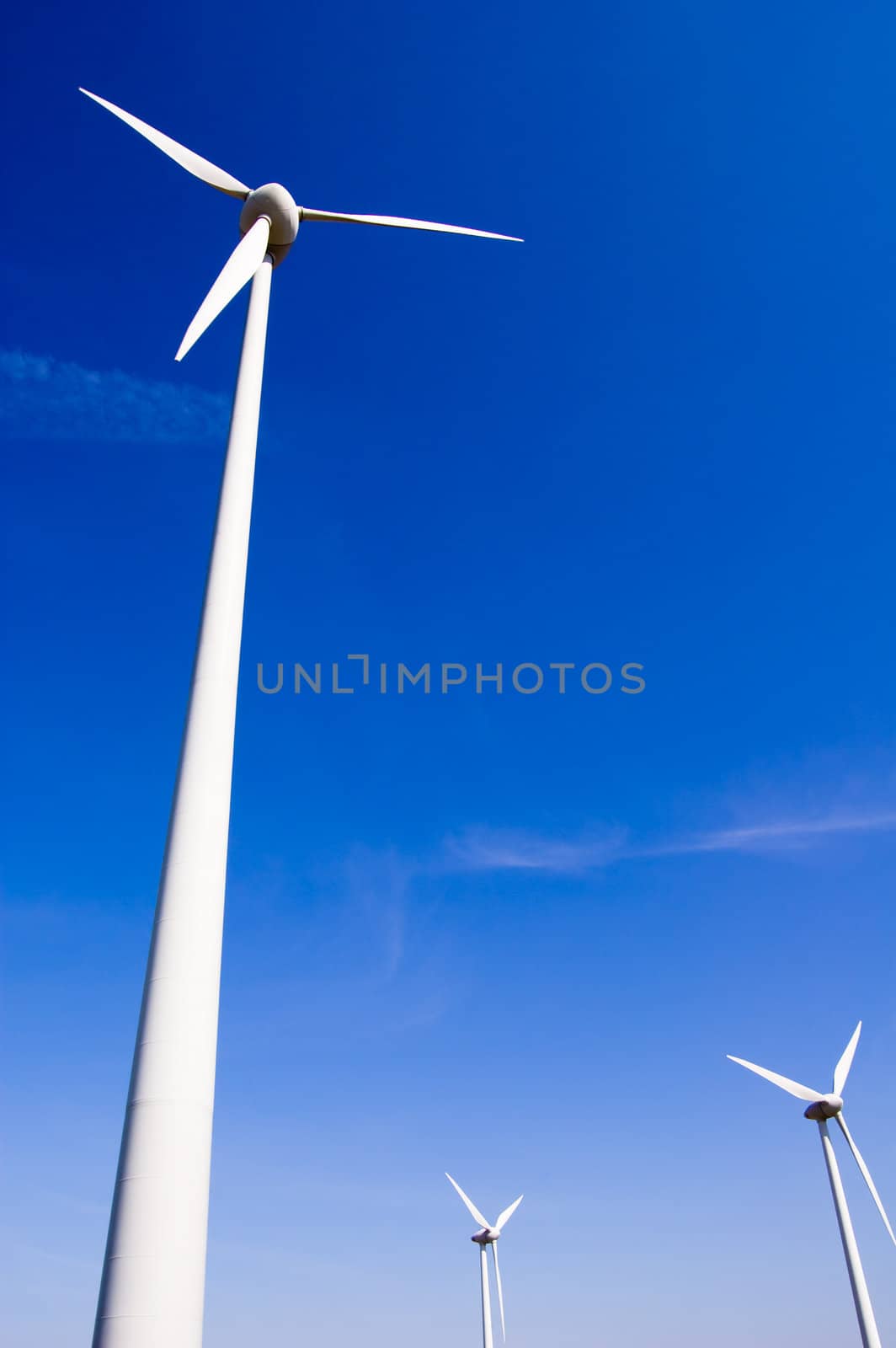 Wind generator against blue sky