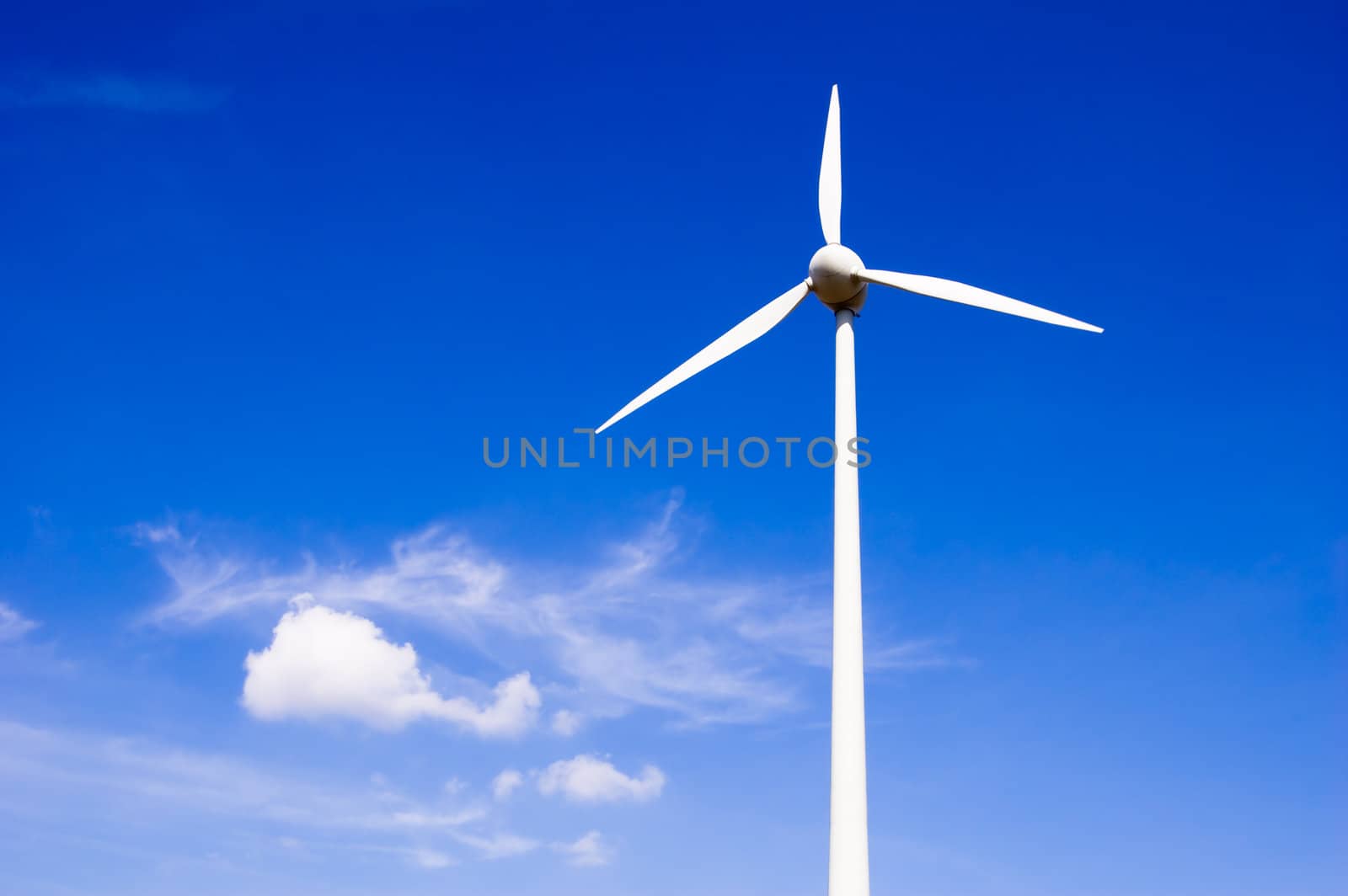 Wind generator against blue sky