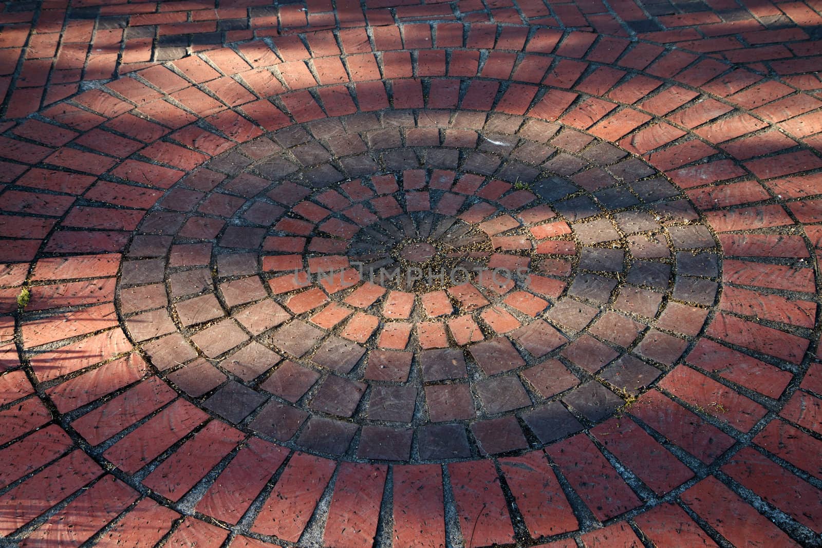 Circles of different colored and sized red bricks