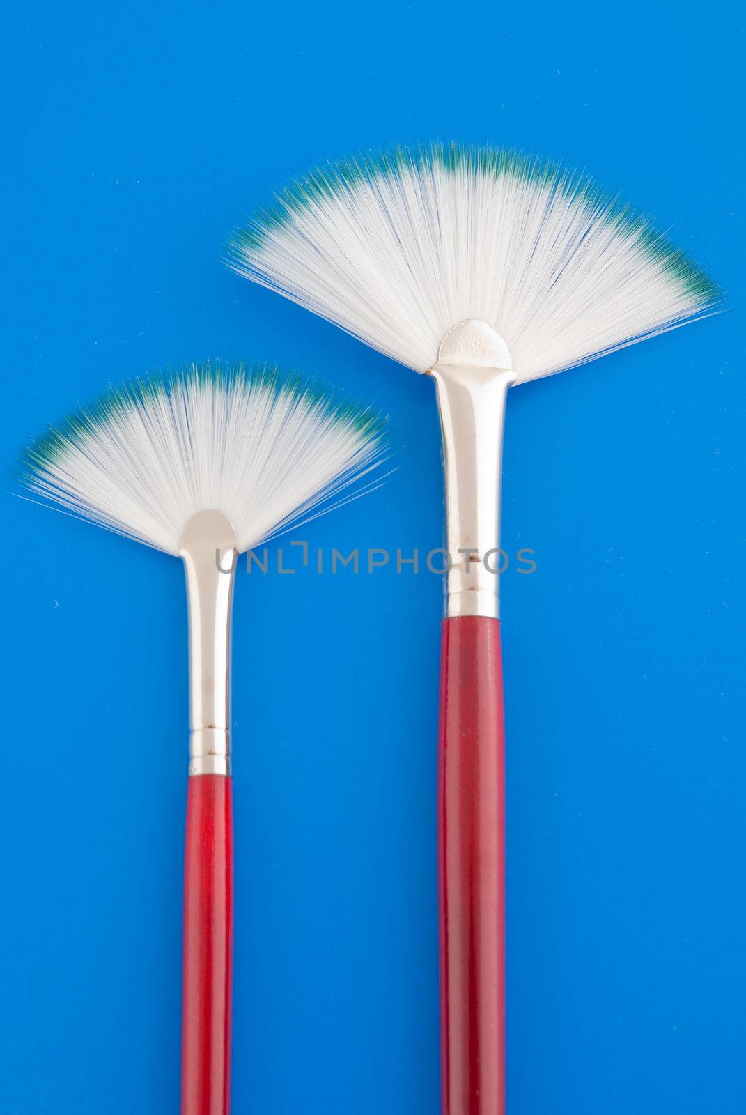 Art brushes on bright blue background.