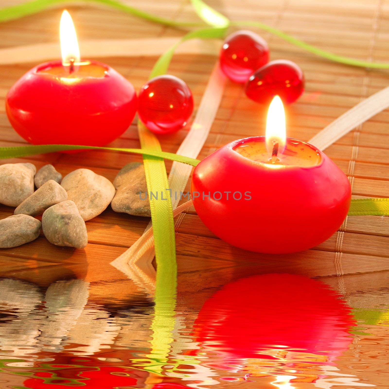 spa candle and water reflection showing zen concept