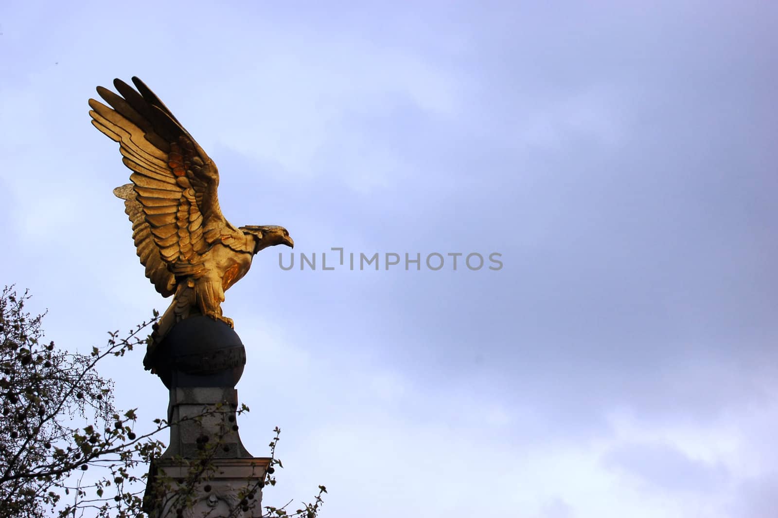 Gold Eagle statue in London, behind London Eye
