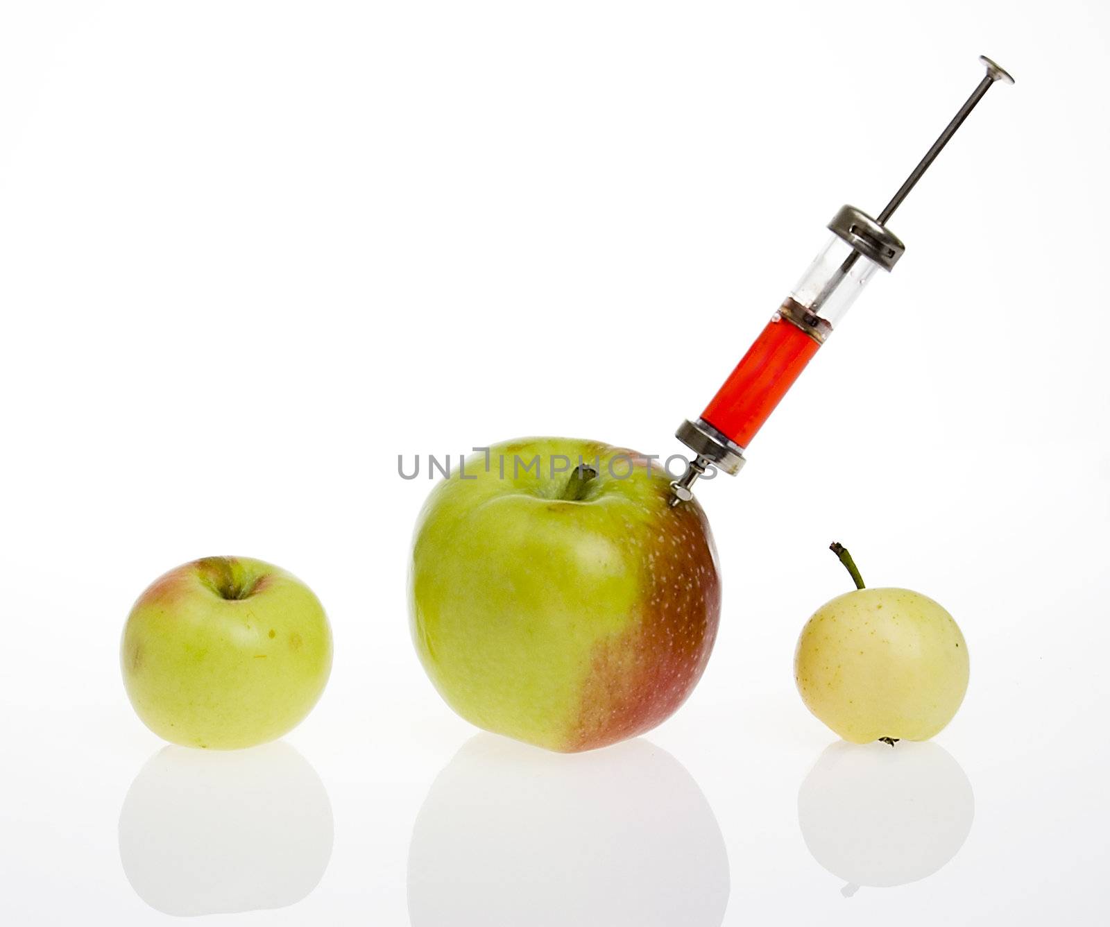 GMO - genetic modified food concept. Big apple with syringe.