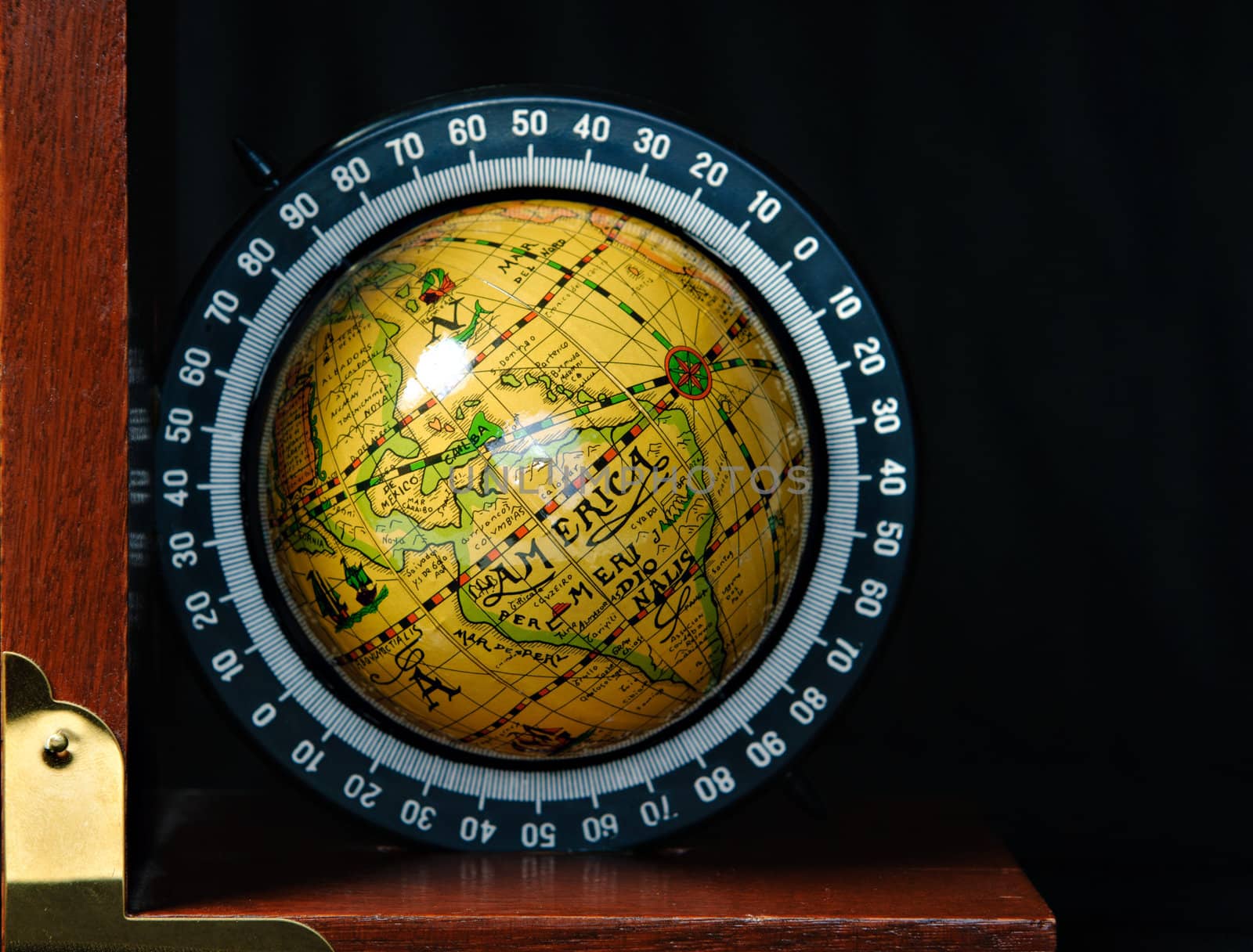 A bookend in the shape of a world globe, shot against a dark background