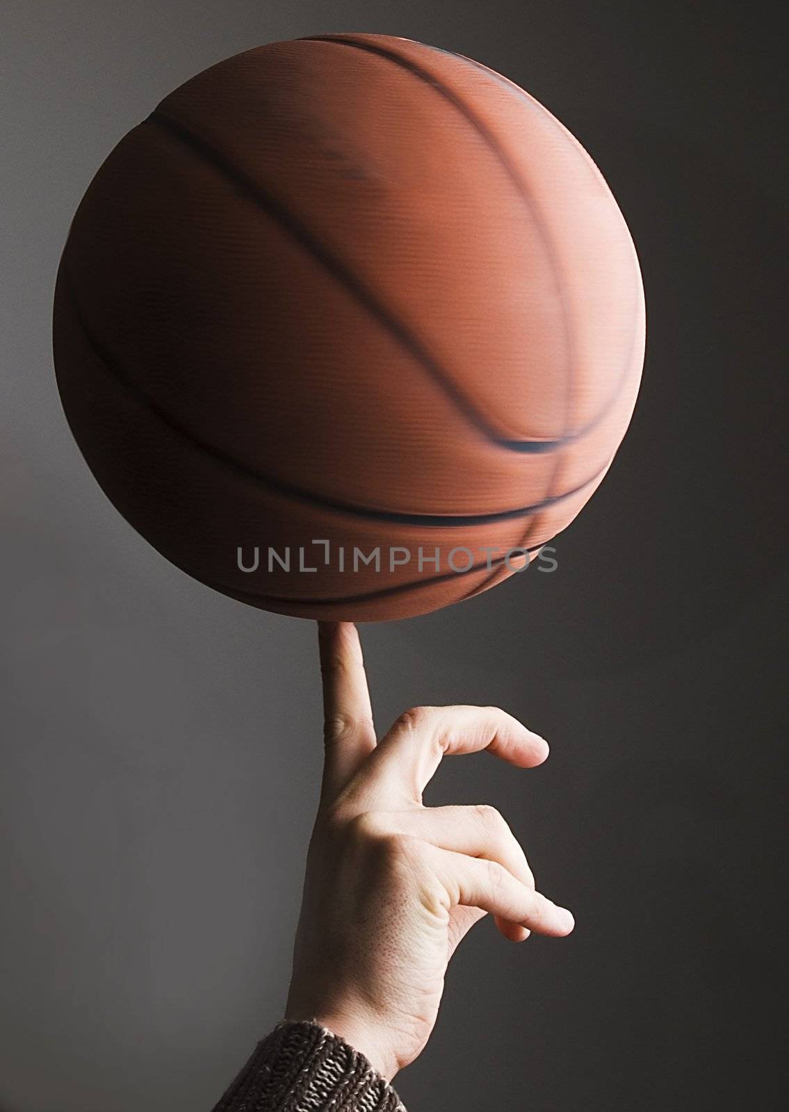 Basket ball rolling on finger by player