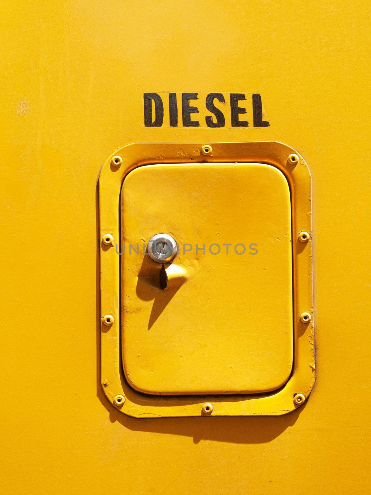 Yellow diesel tank  door on the side of a bus