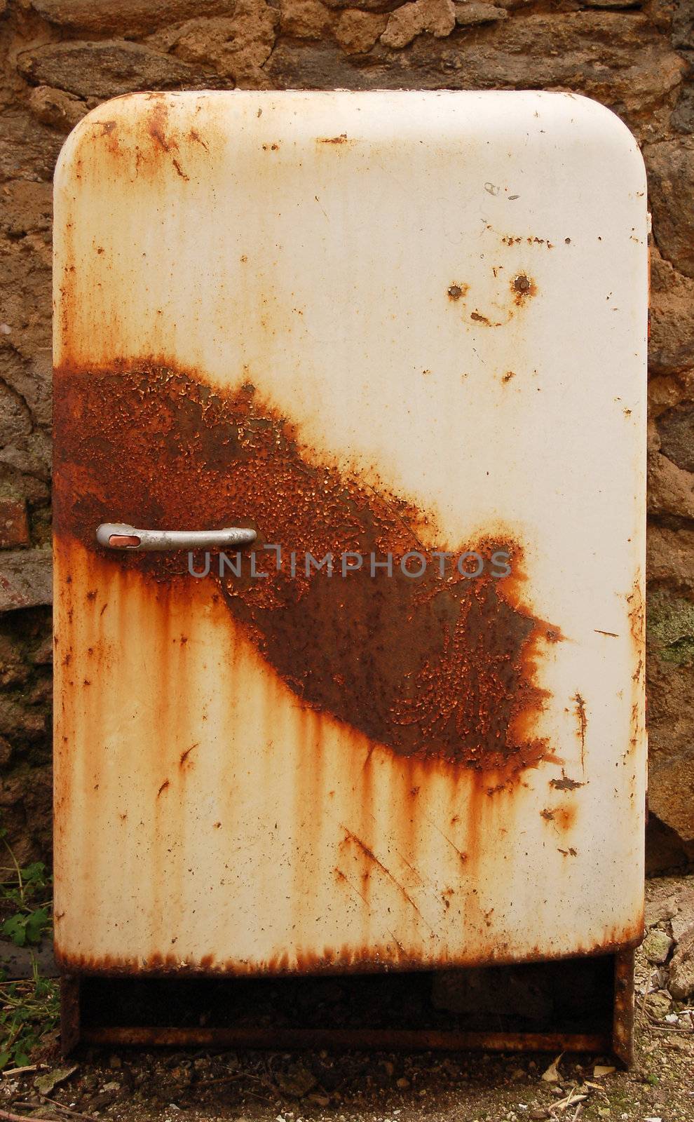 old, broken and rusty fridge