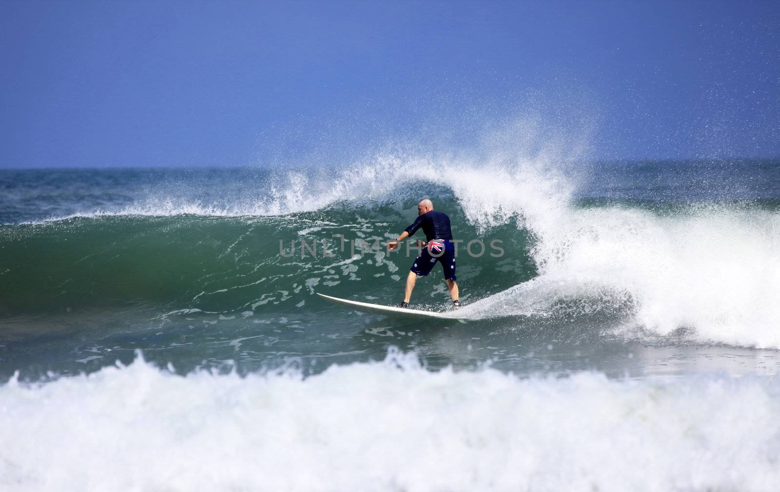 Adult men - the surfer in ocean. Bali. Indonesia