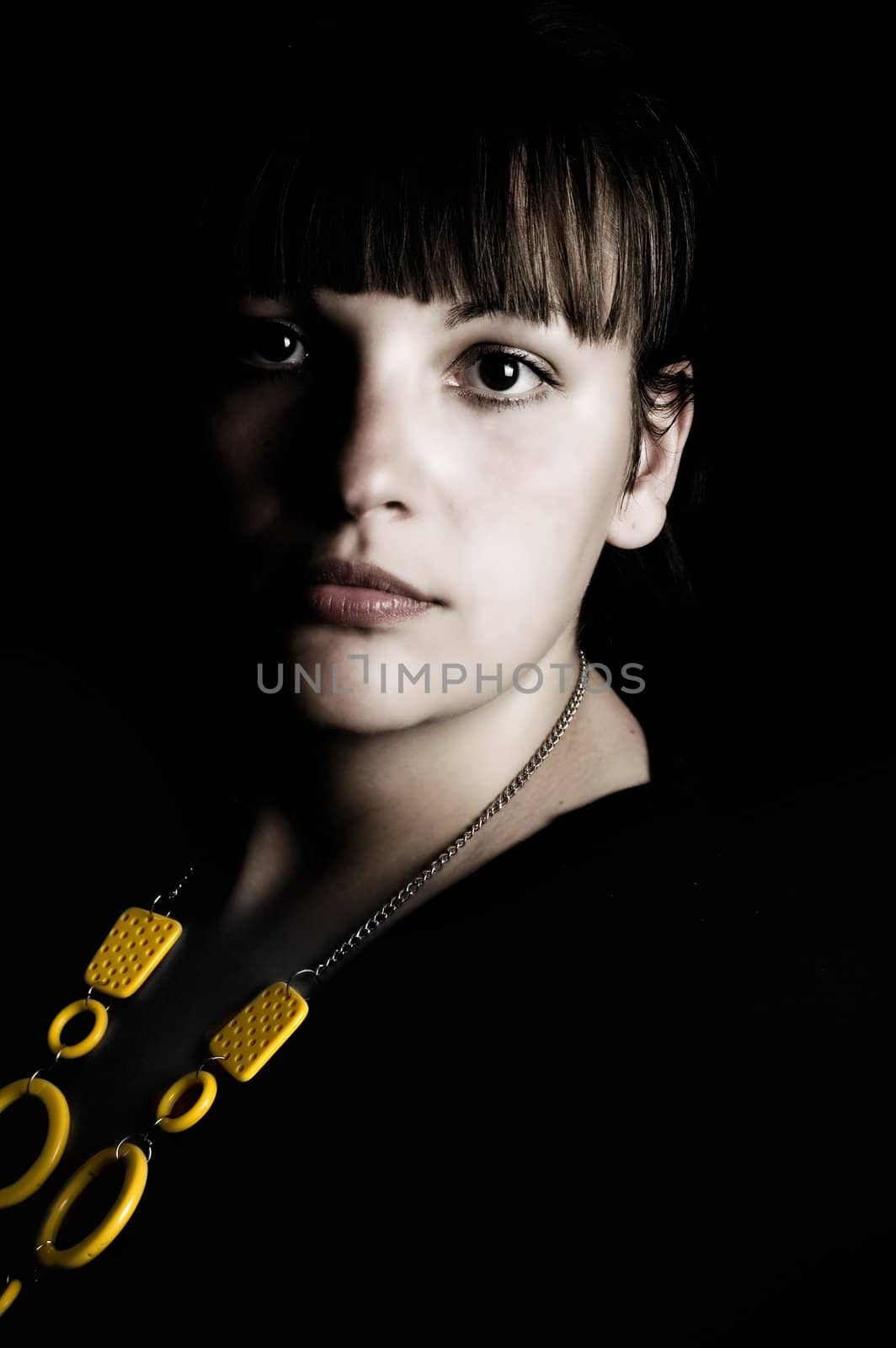 Studio portrait of pretty young woman wearing neacklace.