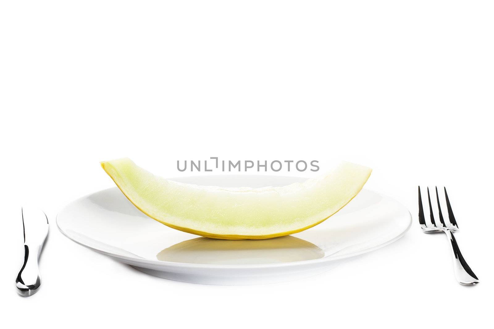 honeydew melon on a plate on white background