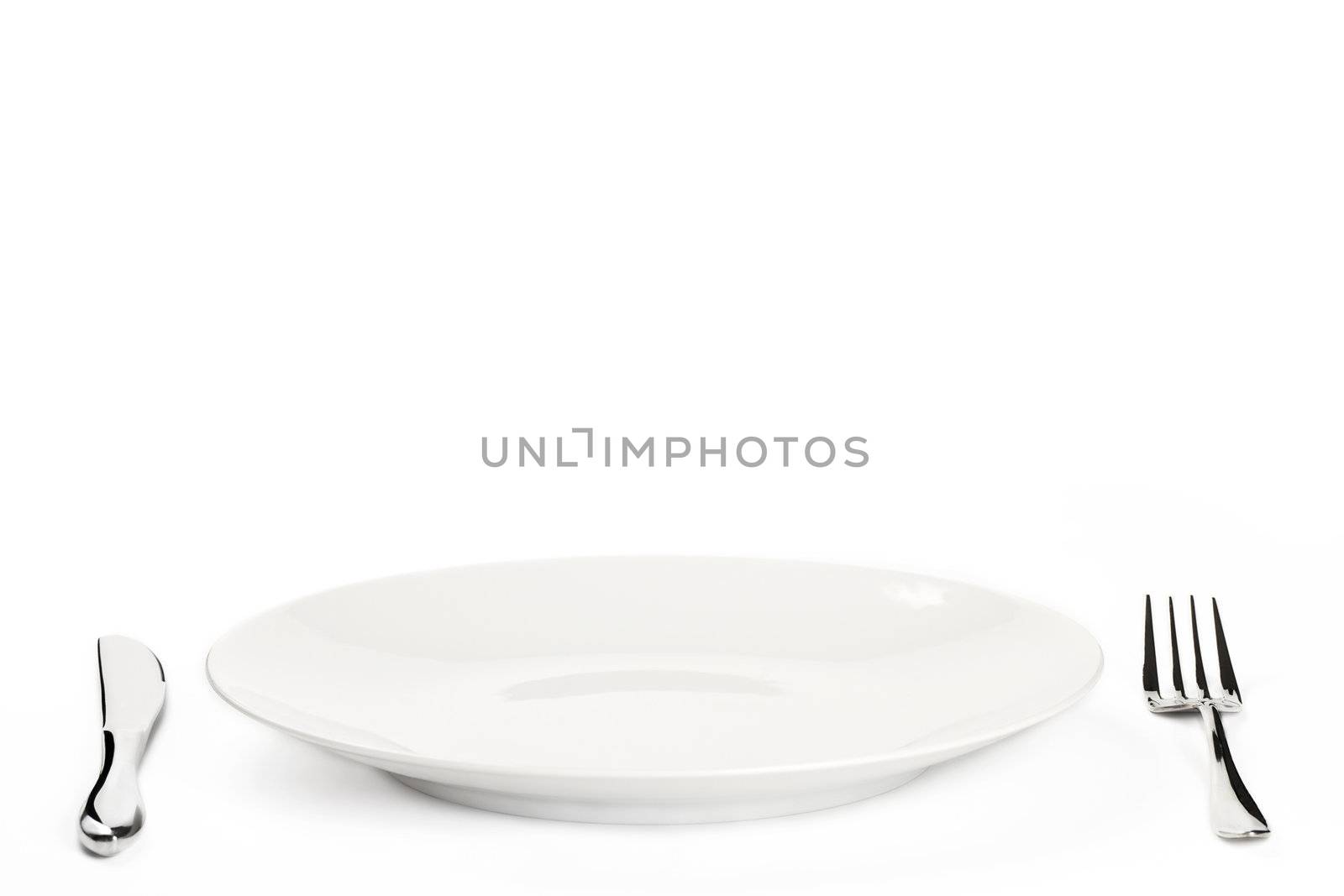 white plate with cutlery on white background