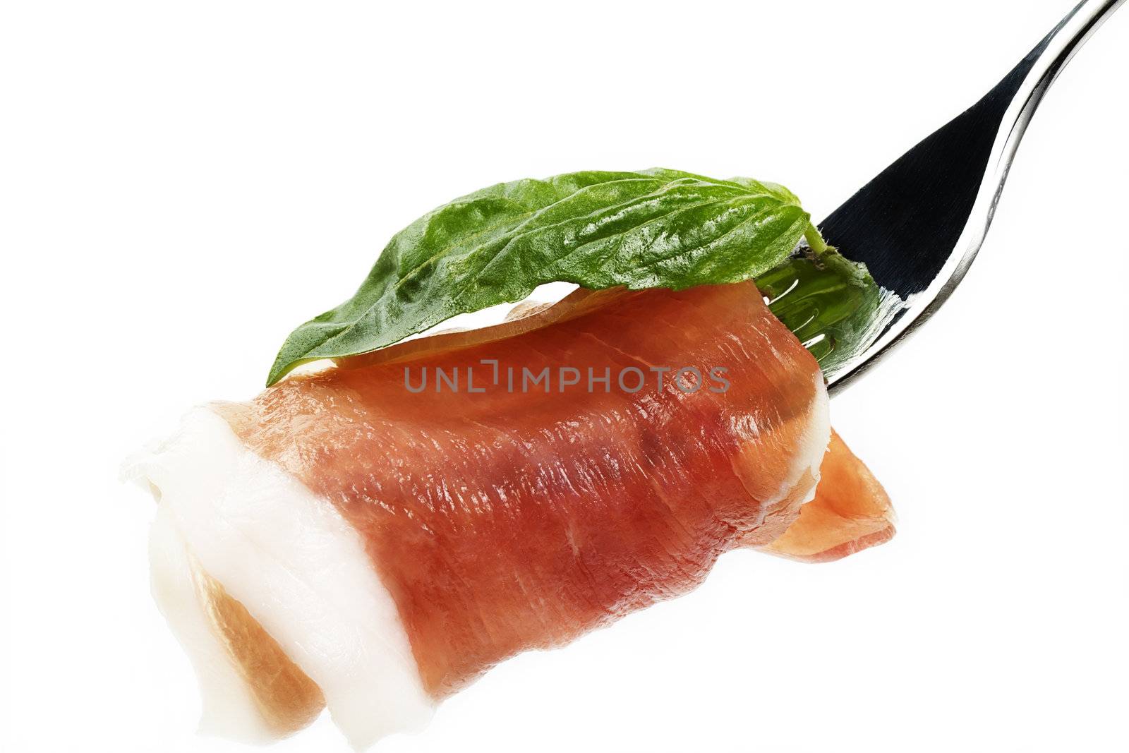 smoked bacon with basil on a fork in front of white background