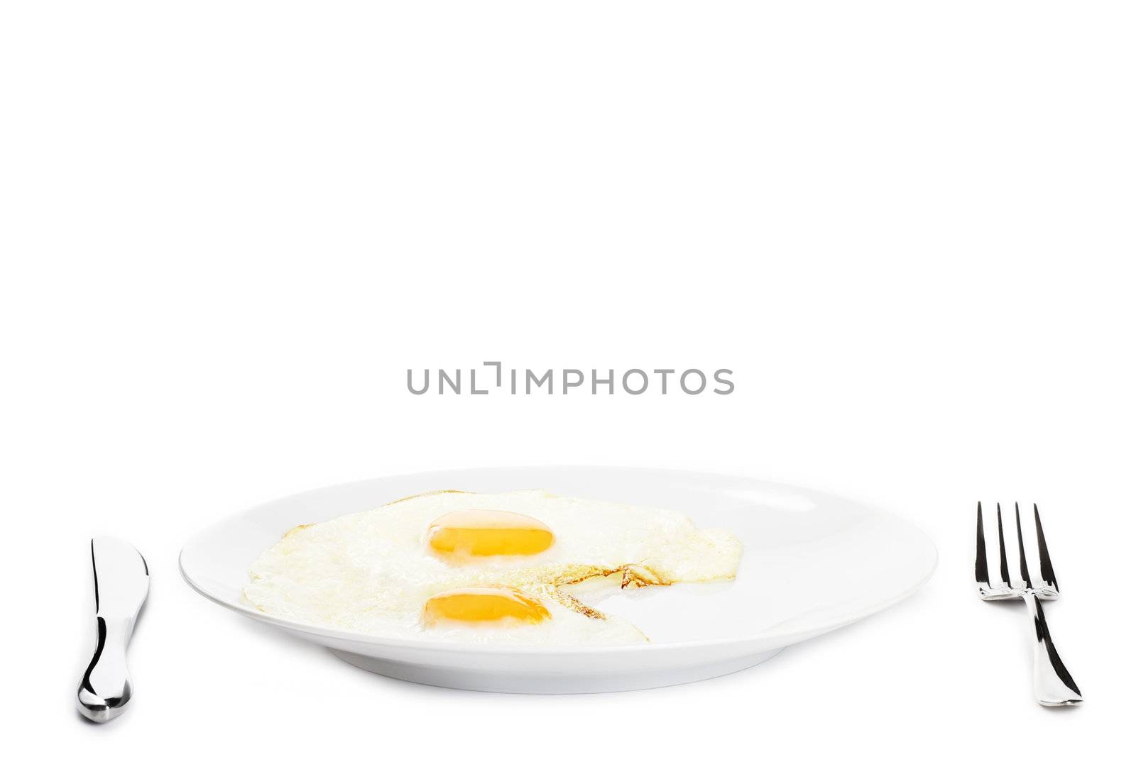 two fried eggs on a plate on white background