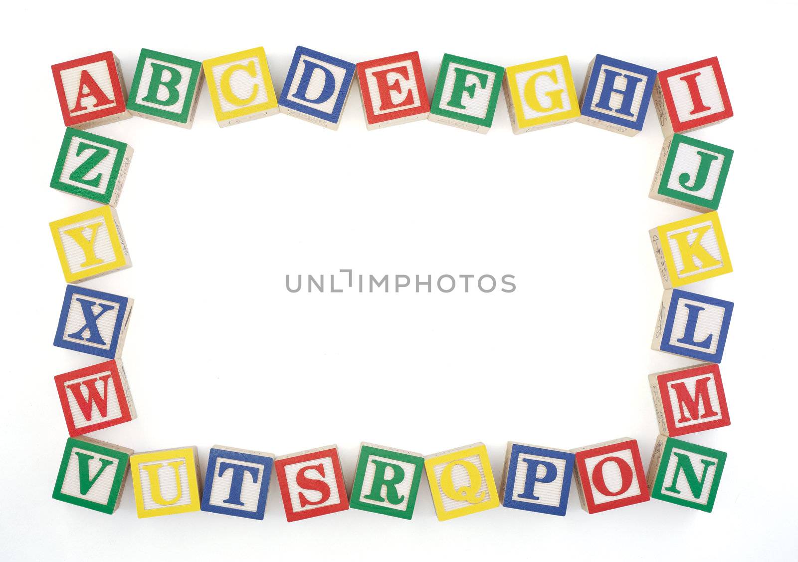 Wooden alphabet blocks arranged to create an horizontal frame isolated on a white background. Clipping path.