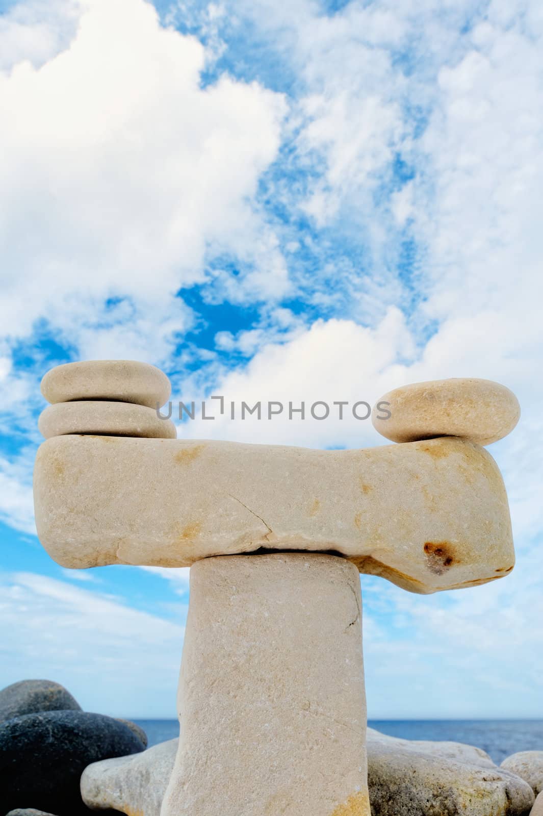 Stack of pebbles against the blue sky