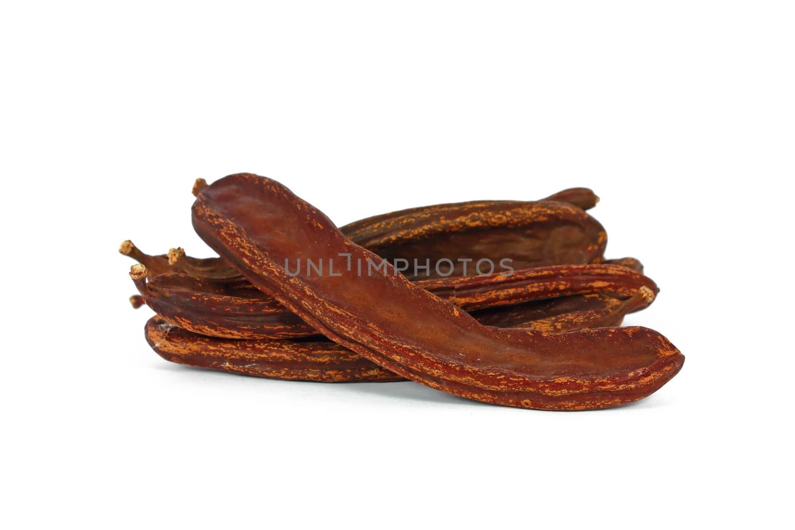 Bunch of dried carob isolated on white
