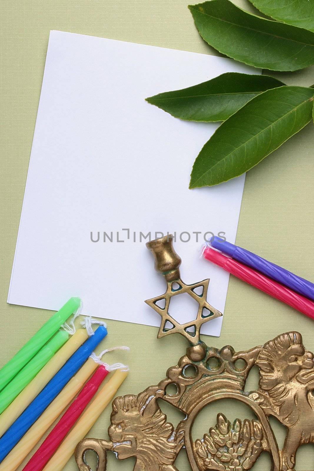 Menorah and candles next to a piece of white paper. Add your text to the paper.