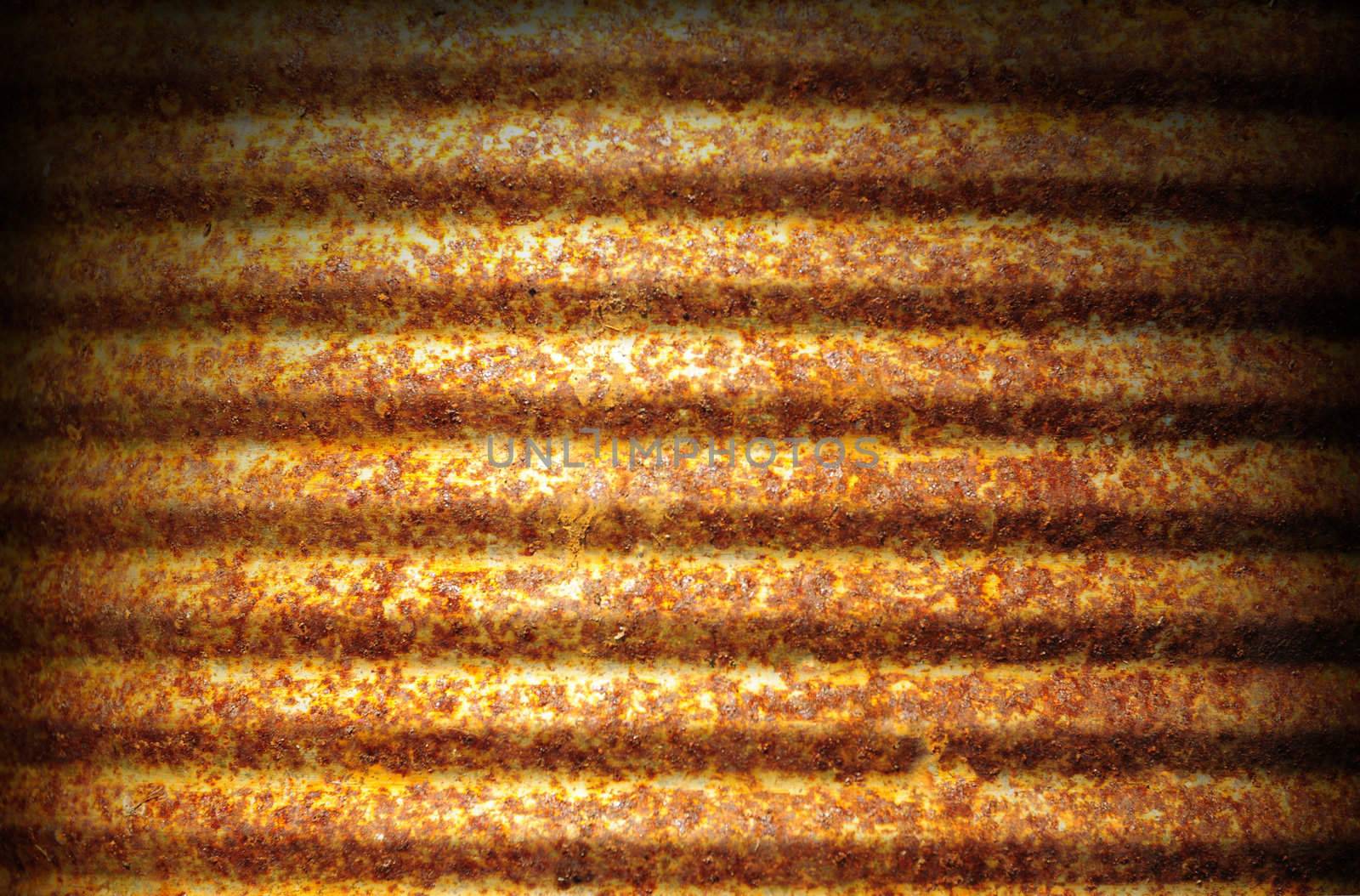 Rusty corrugated metal can surface lit dramatically from above