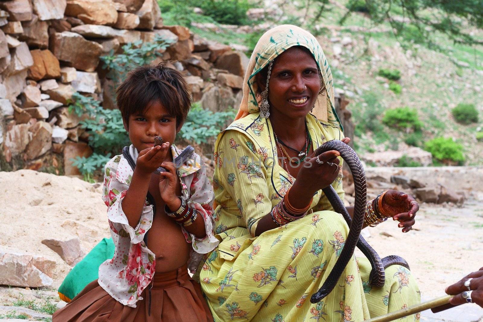 woman and young boy with snake