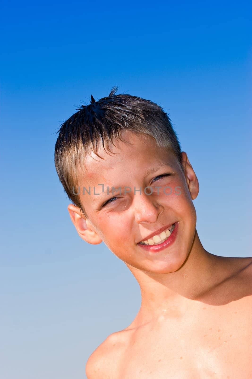 portrait series: summer boy portrait over blue sky