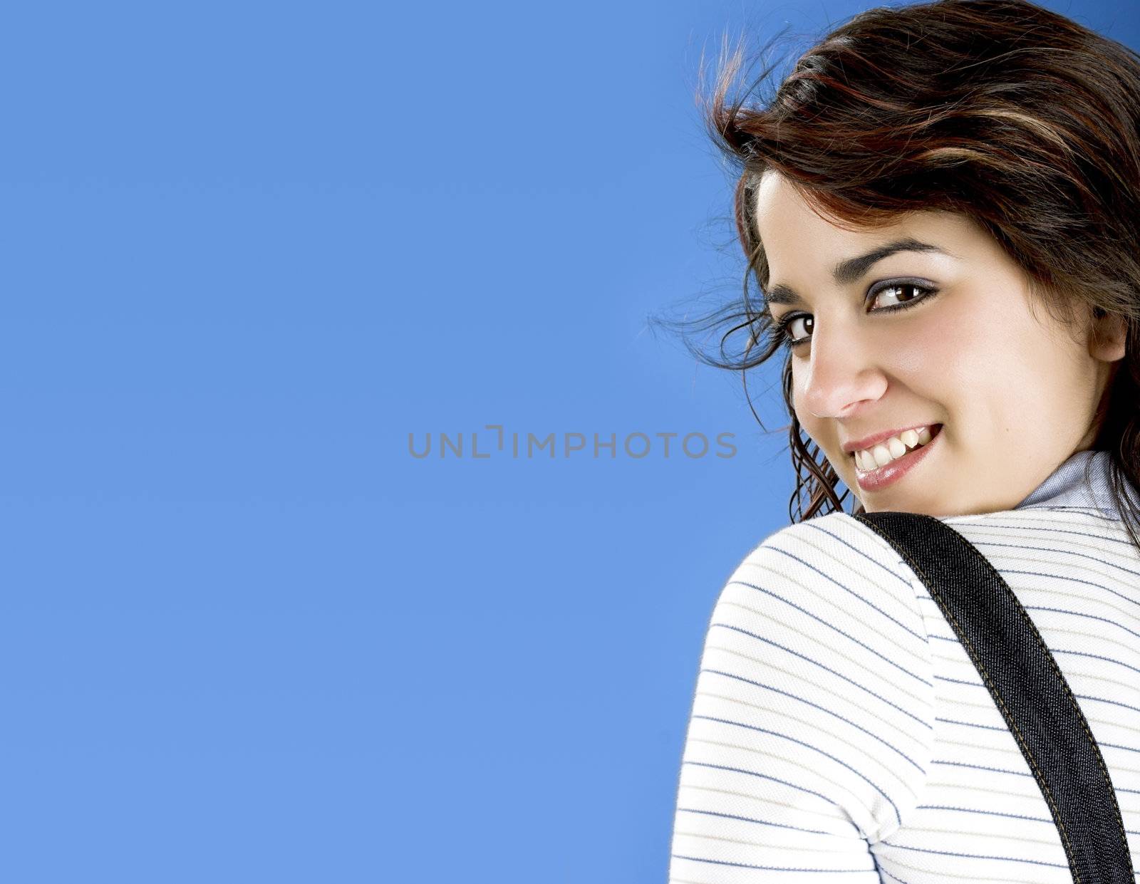 Portrait of a young and beautiful woman on a blue background