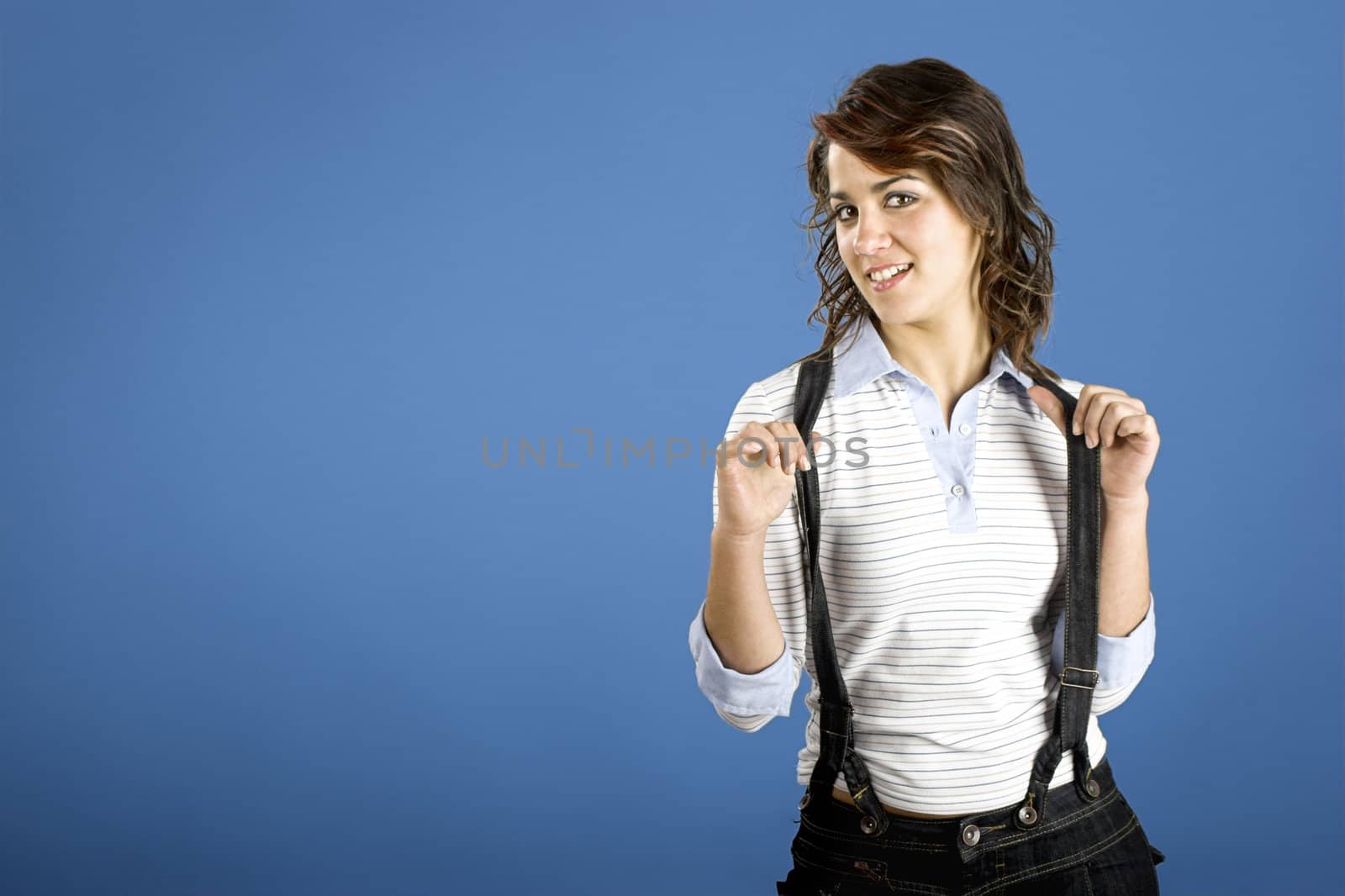 Portrait of a beautiful young and attractive woman posing on a blue background