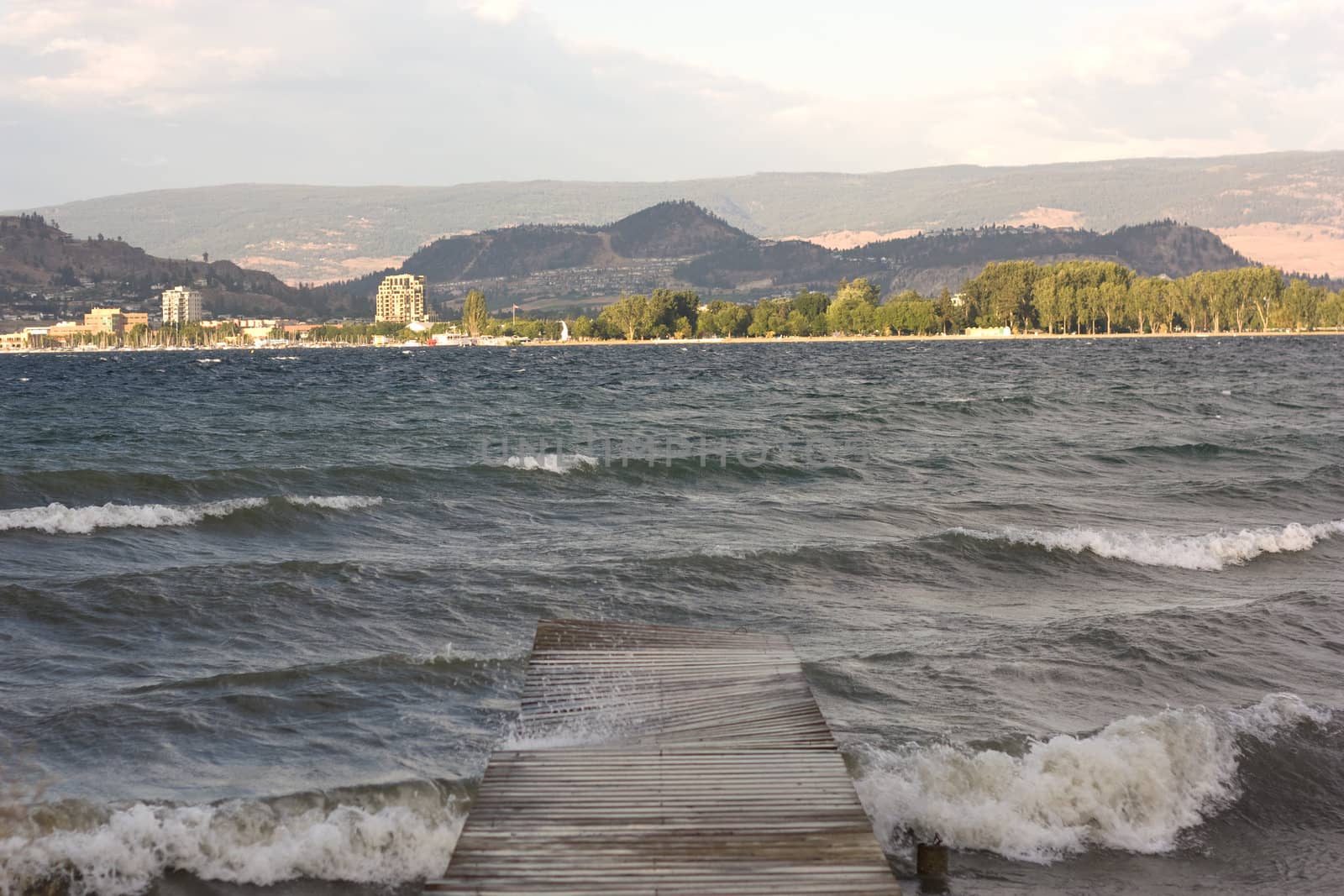 mountain and lake view from a wooden footbridge
