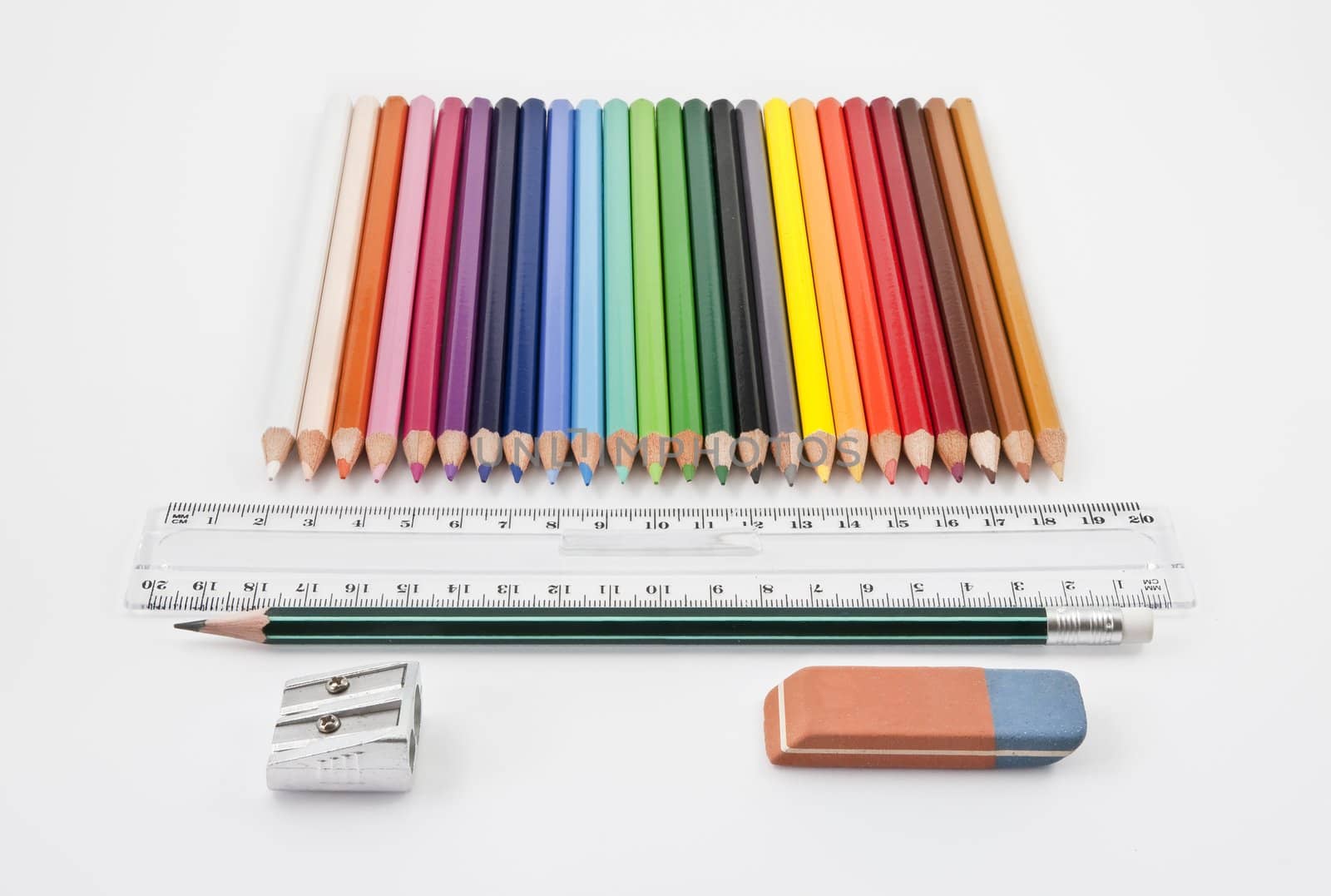 Straight alignment of basic school supplies on a white background